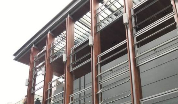 Building facade with pivoting louvered windows.