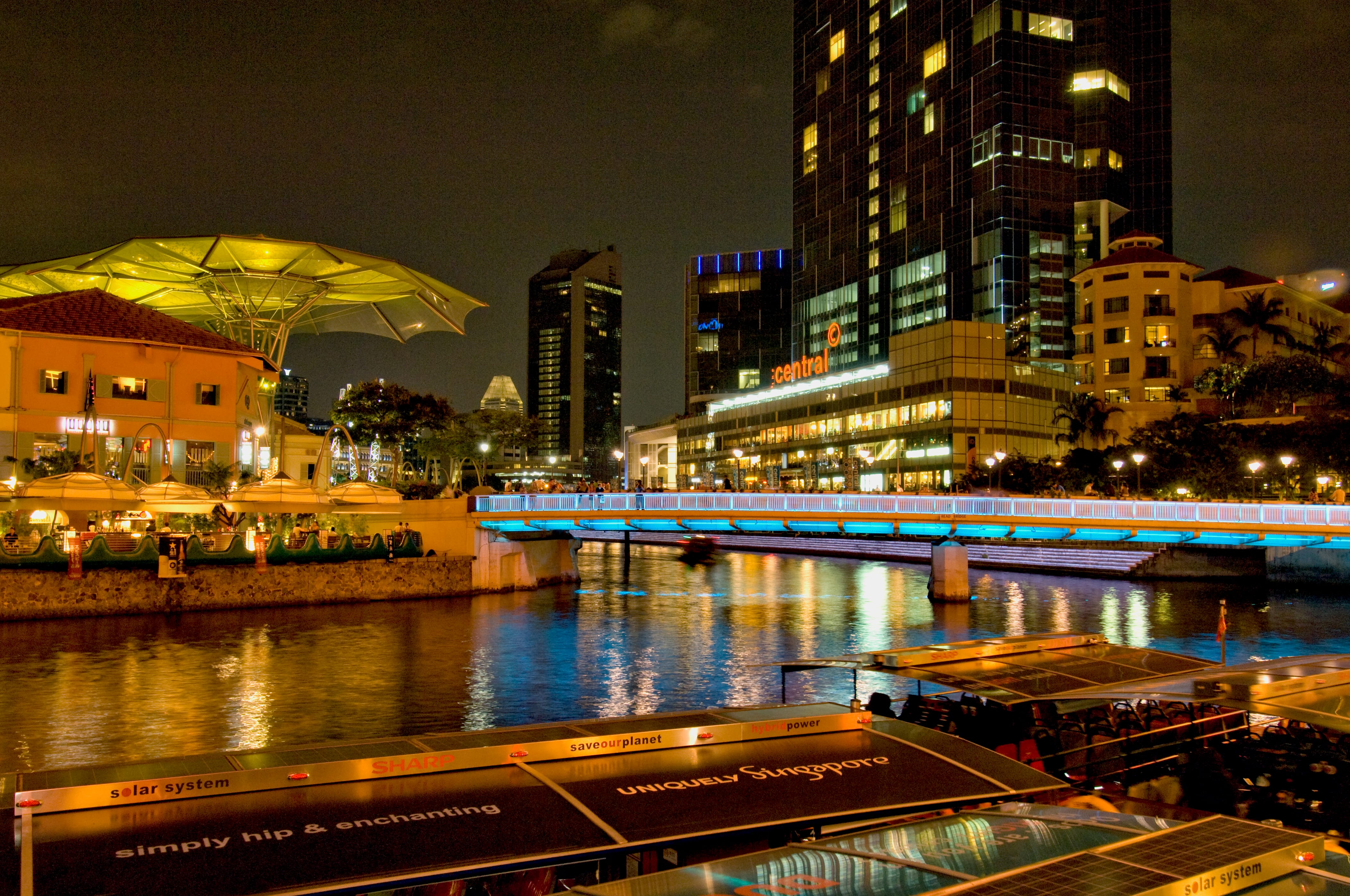 Read Bridge illuminated at night, spanning the Singapore River amid Clarke Quay's city lights