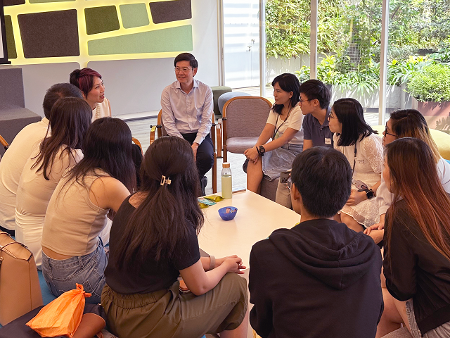 Group engaging in a discussion around a table.