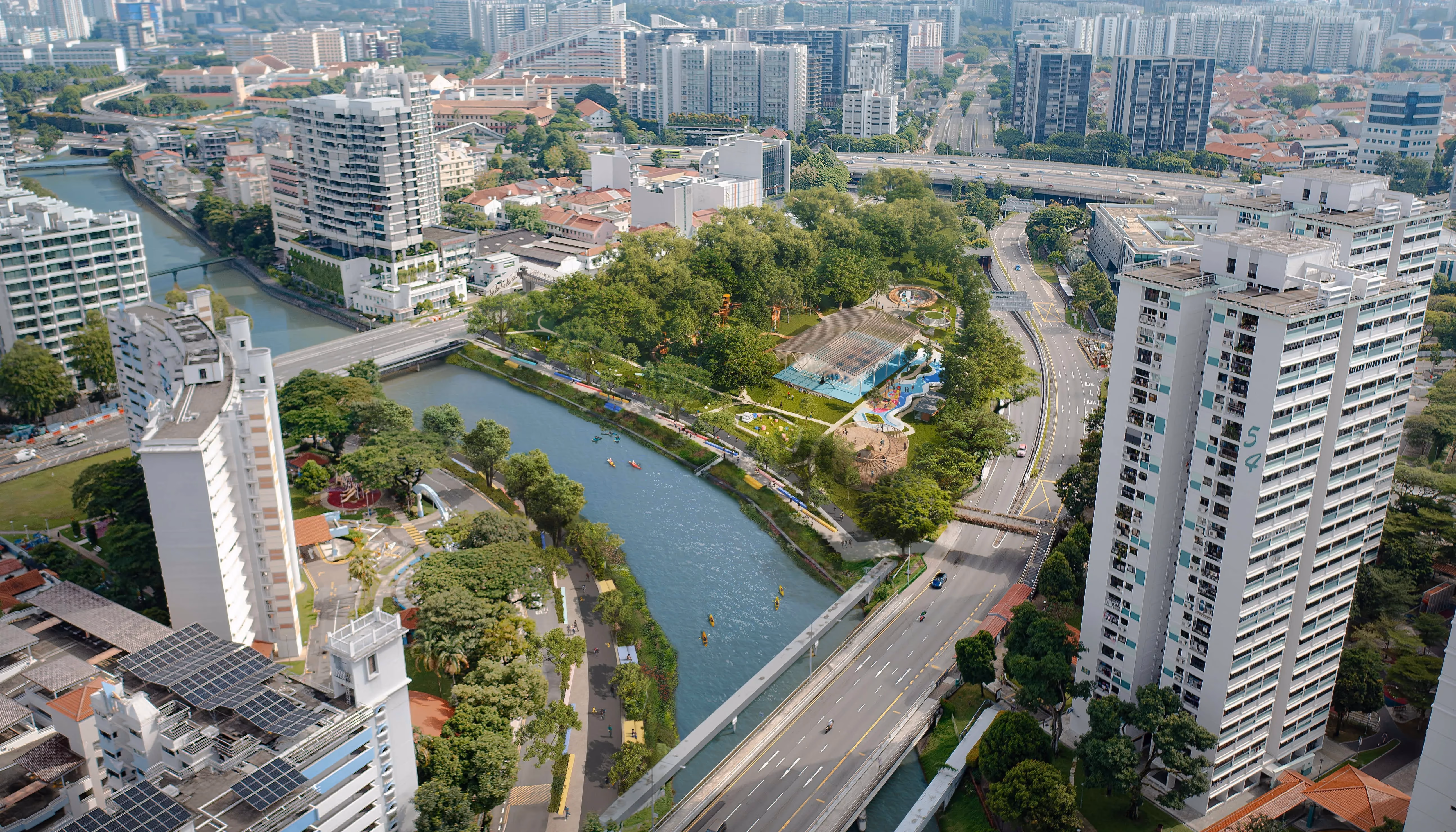 Aerial view of Singapore city with a river, park, and buildings.