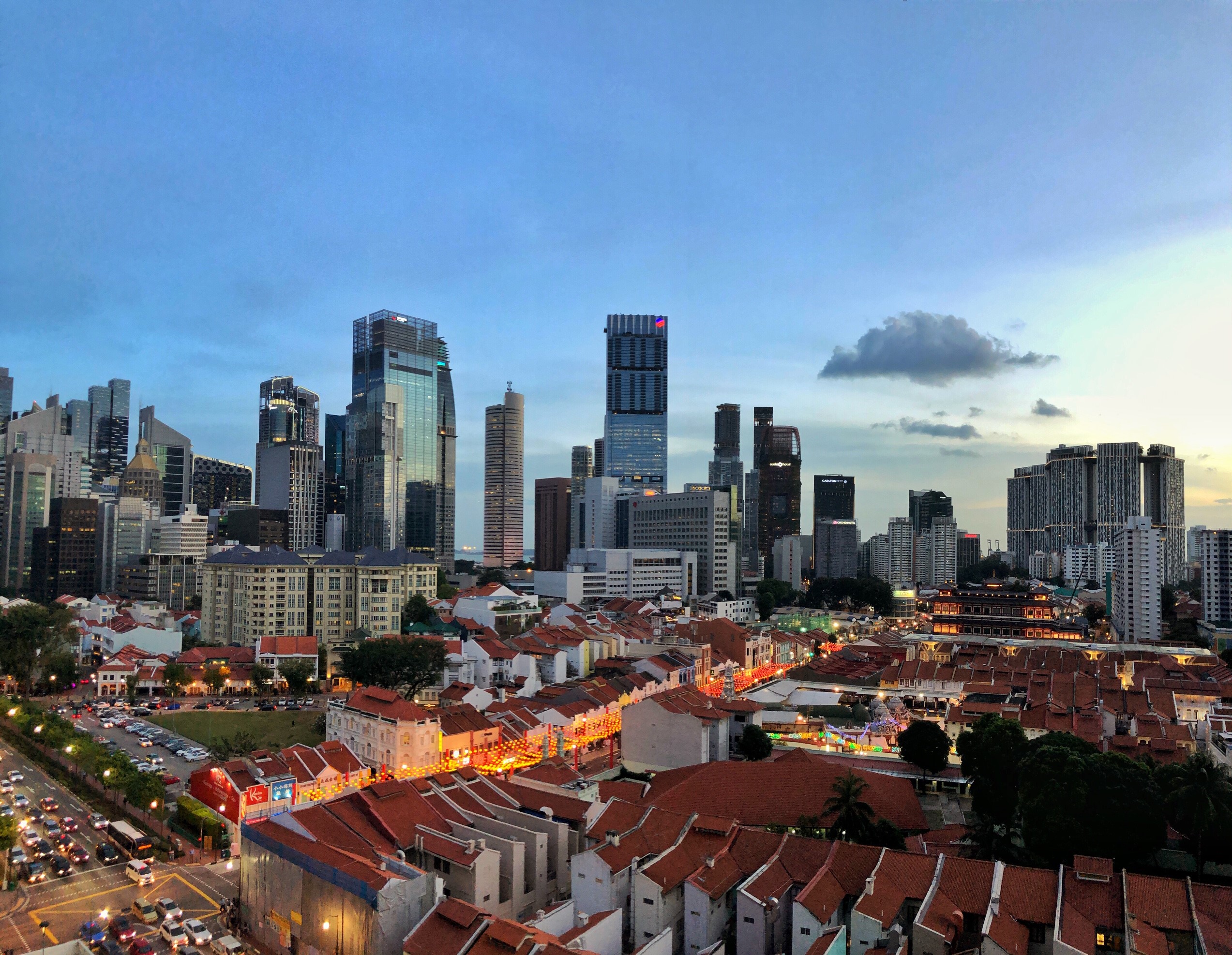 Skyline of Tanjong Pagar with Chinatown shophouses and city towers at dusk.