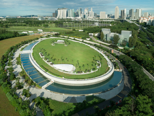 Aerial view of Gardens by the Bay East park in Singapore, featuring green spaces and the city skyline.