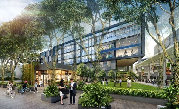 Office building with green space and trees. People are walking and biking.