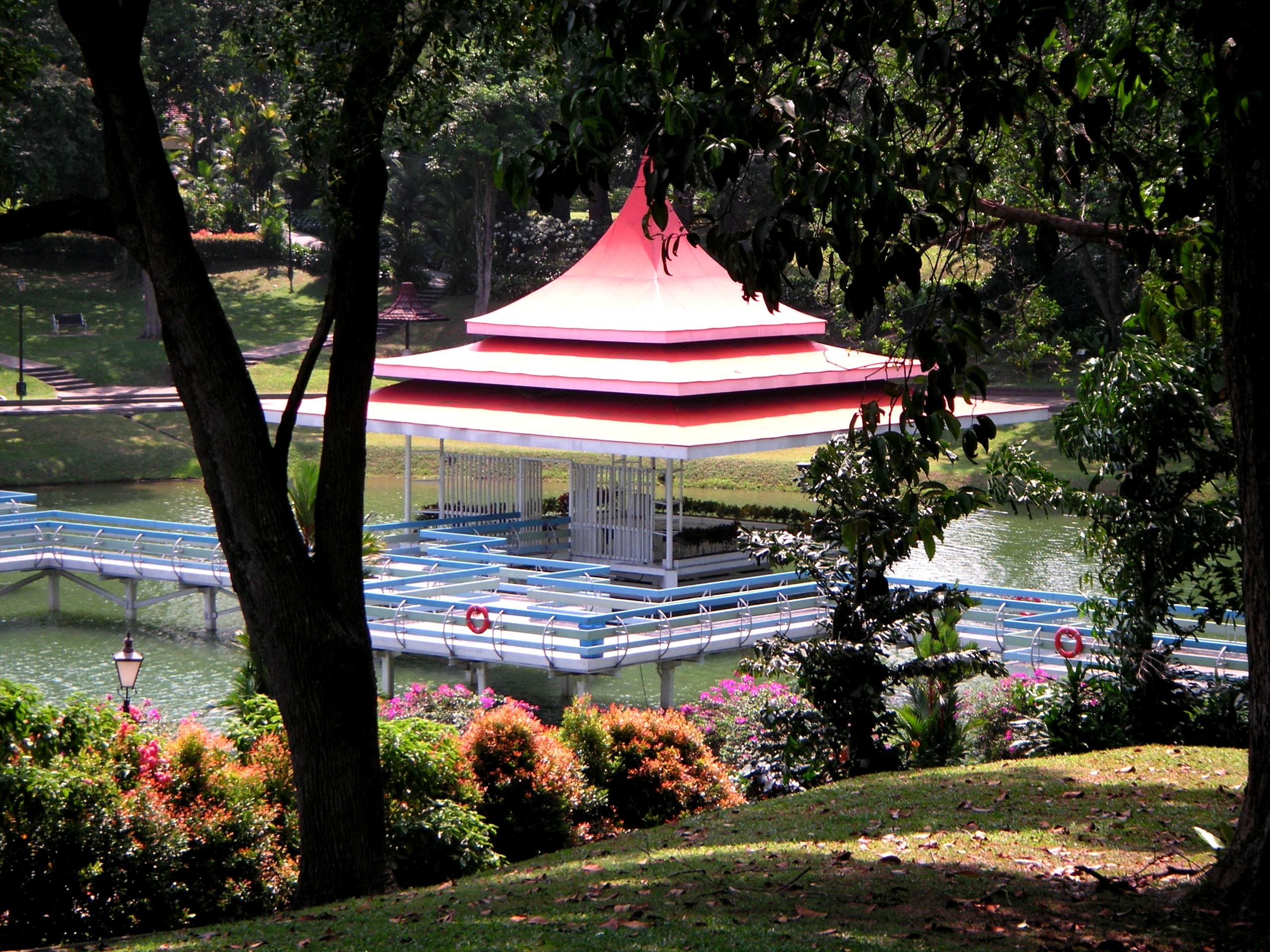 Elevated view of the floating bandstand and zig-zag bridge framed by trees