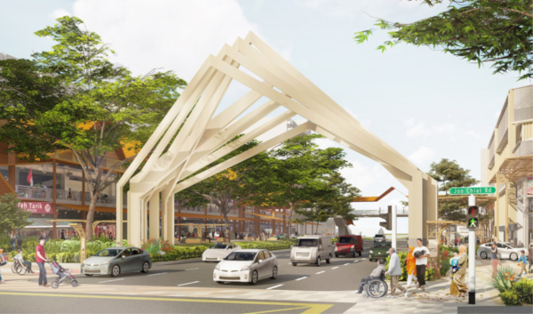 Street scene with a wooden archway over a road. People walk on sidewalks, and cars drive on the road. Trees line the street.