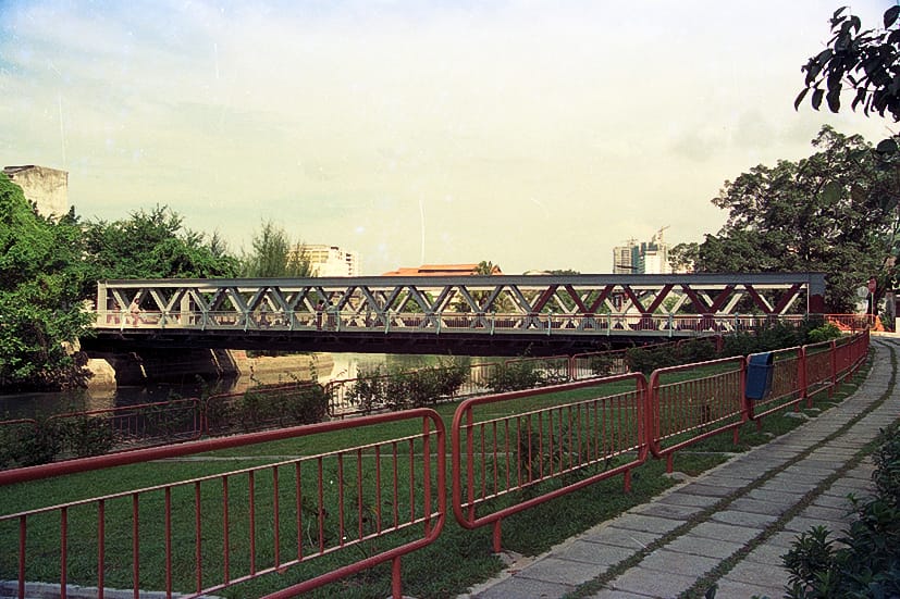 Historic view of Ord Bridge crossing the Singapore River, seen from the riverside path