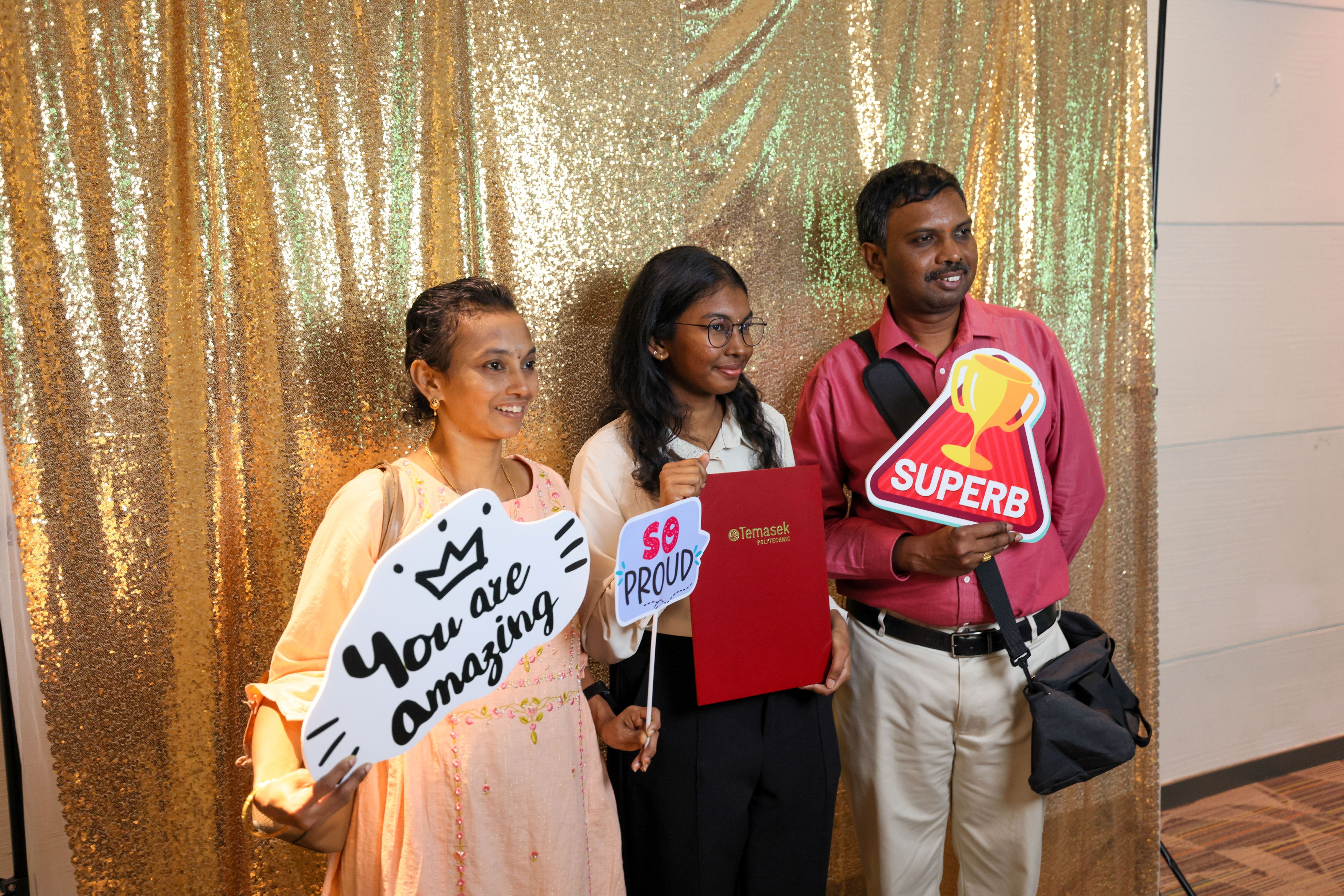 Image of students and staff take a photo at the photo booth the TP Scholarships Presentation