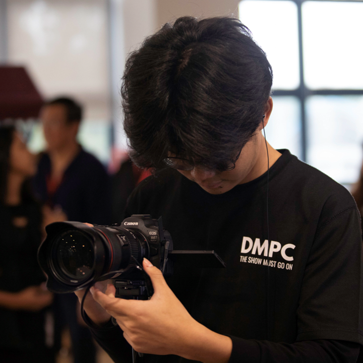 Image of a DMPC member working behind-the-scenes at an event 6