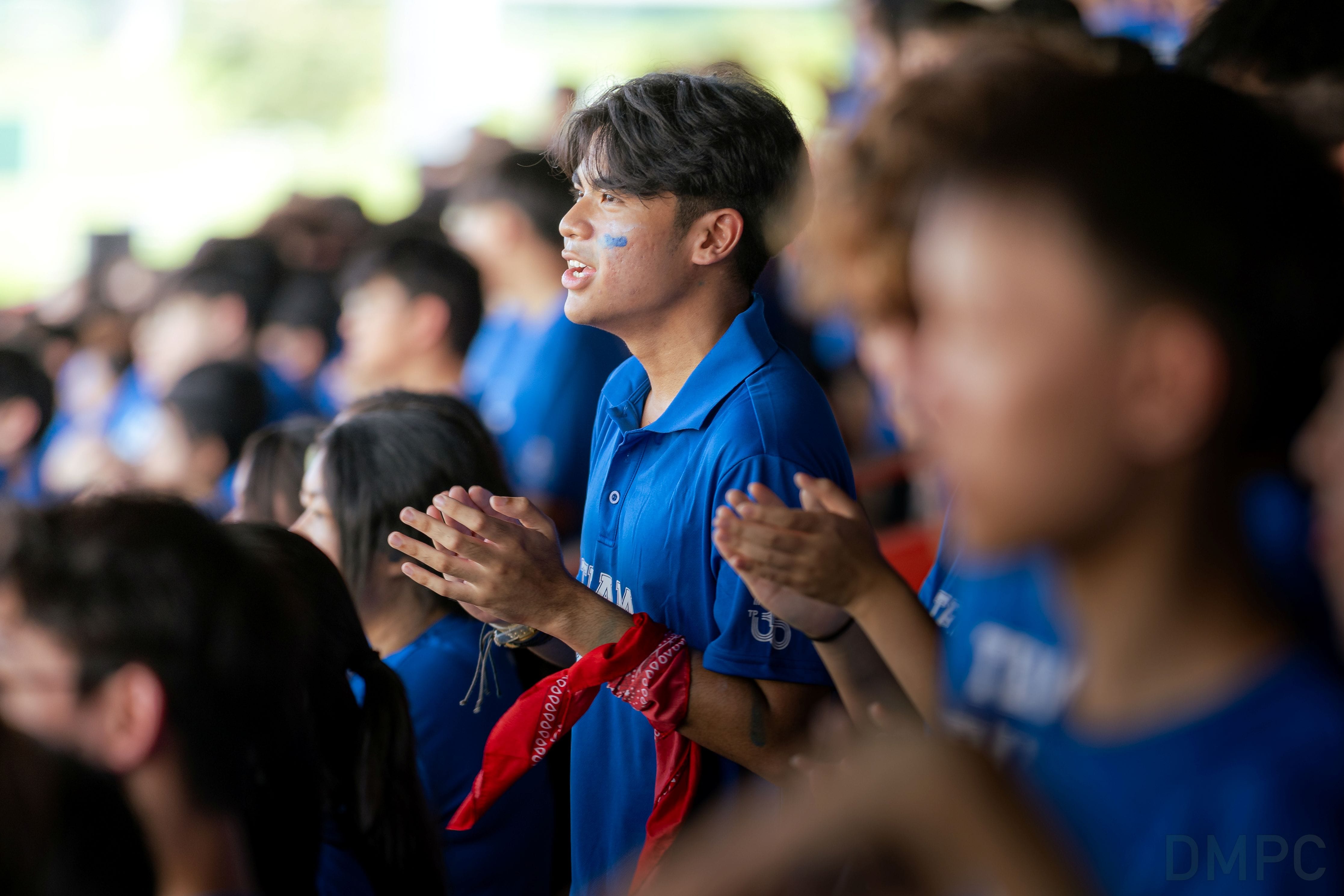 Image of a group of students from School of Informatics & IT cheering at the finale