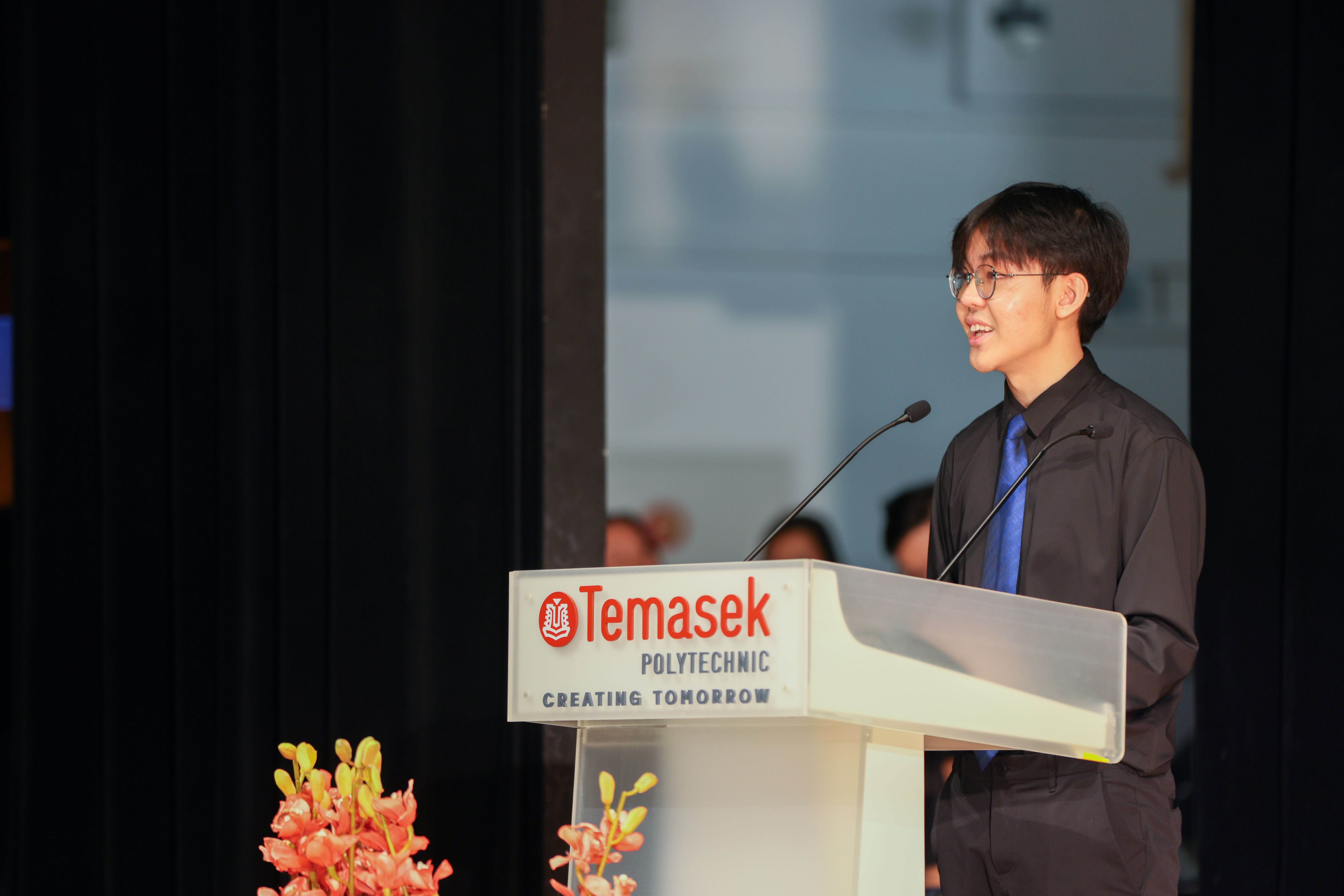 Image of a student speaker addressing the audience at the TP Scholarships Presentation