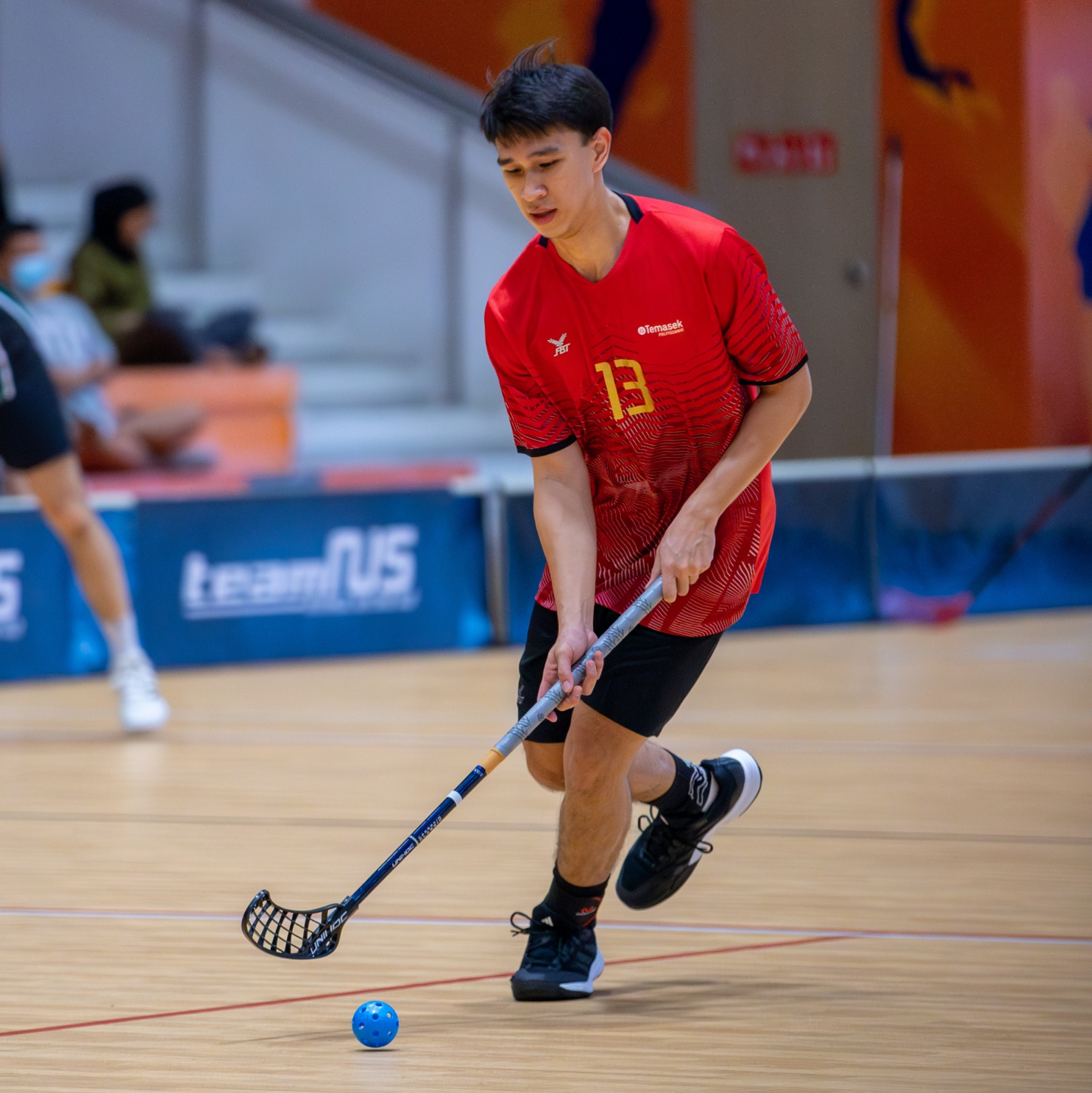 Image of a Floorball CCA student playing the sport at a competition