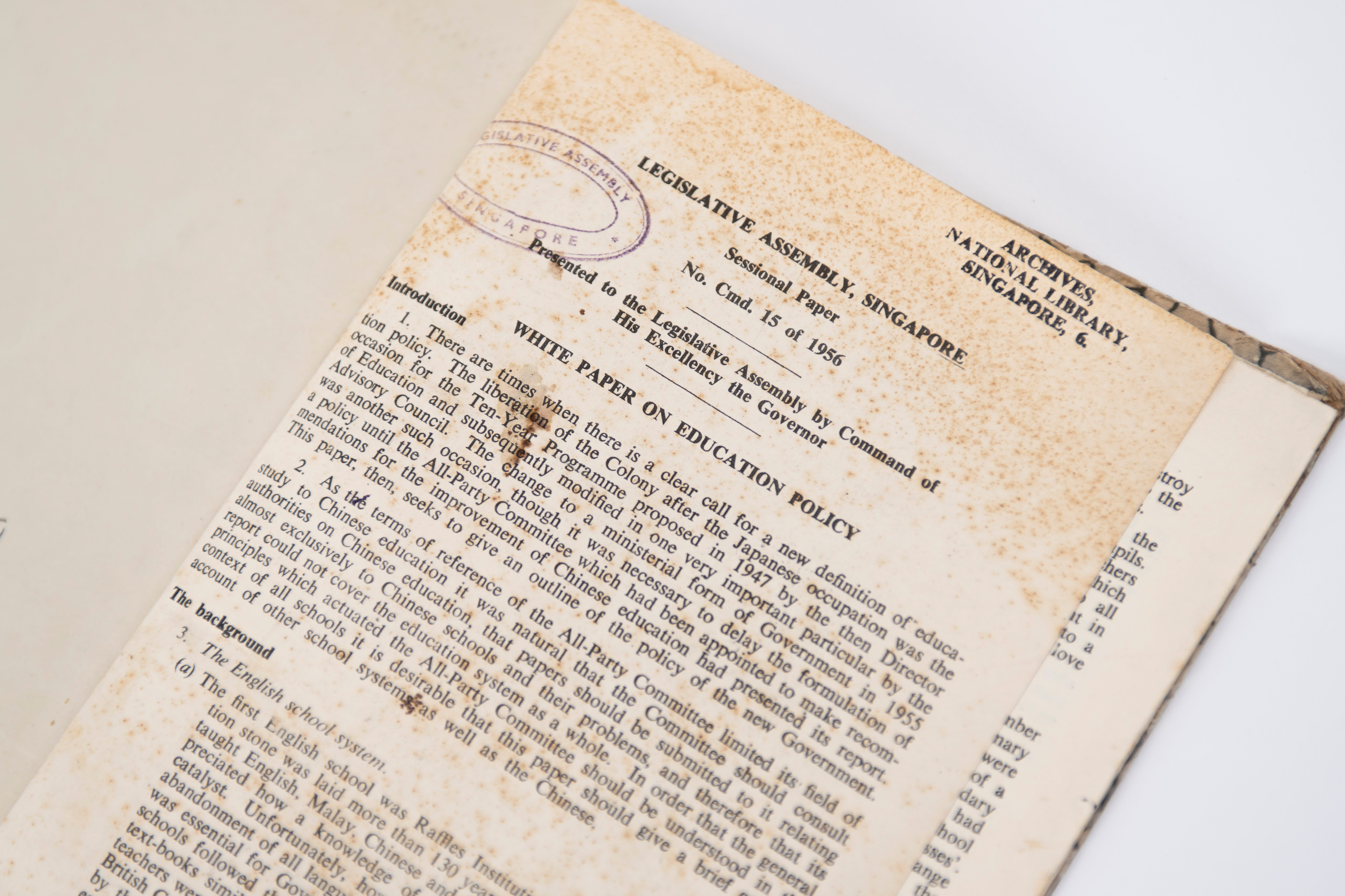 Aged, stained document titled White Paper on Education Policy, Legislative Assembly Singapore, 1956.