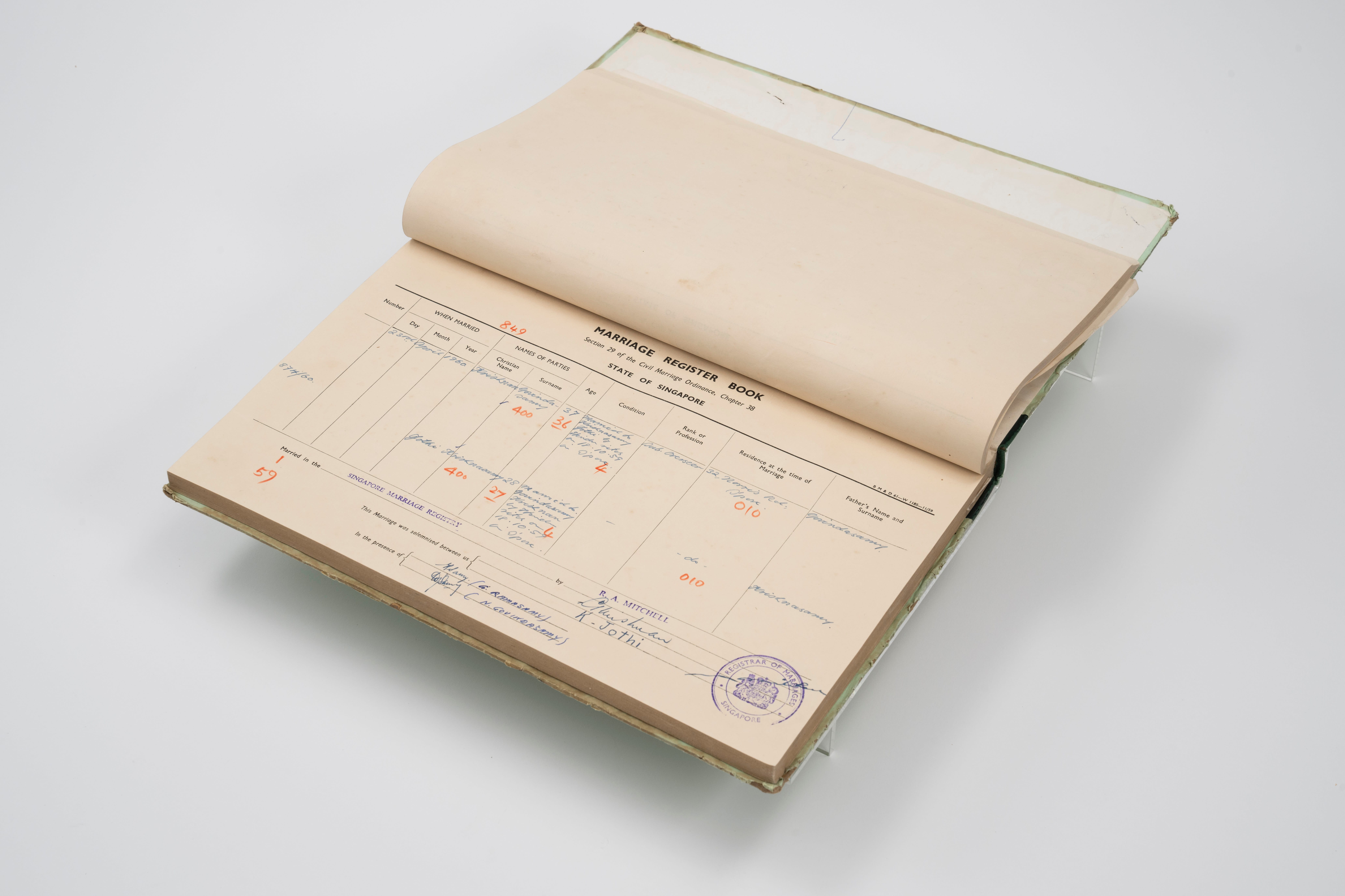 Open register book showing a marriage record form with handwritten entries and a blue stamp on the page.