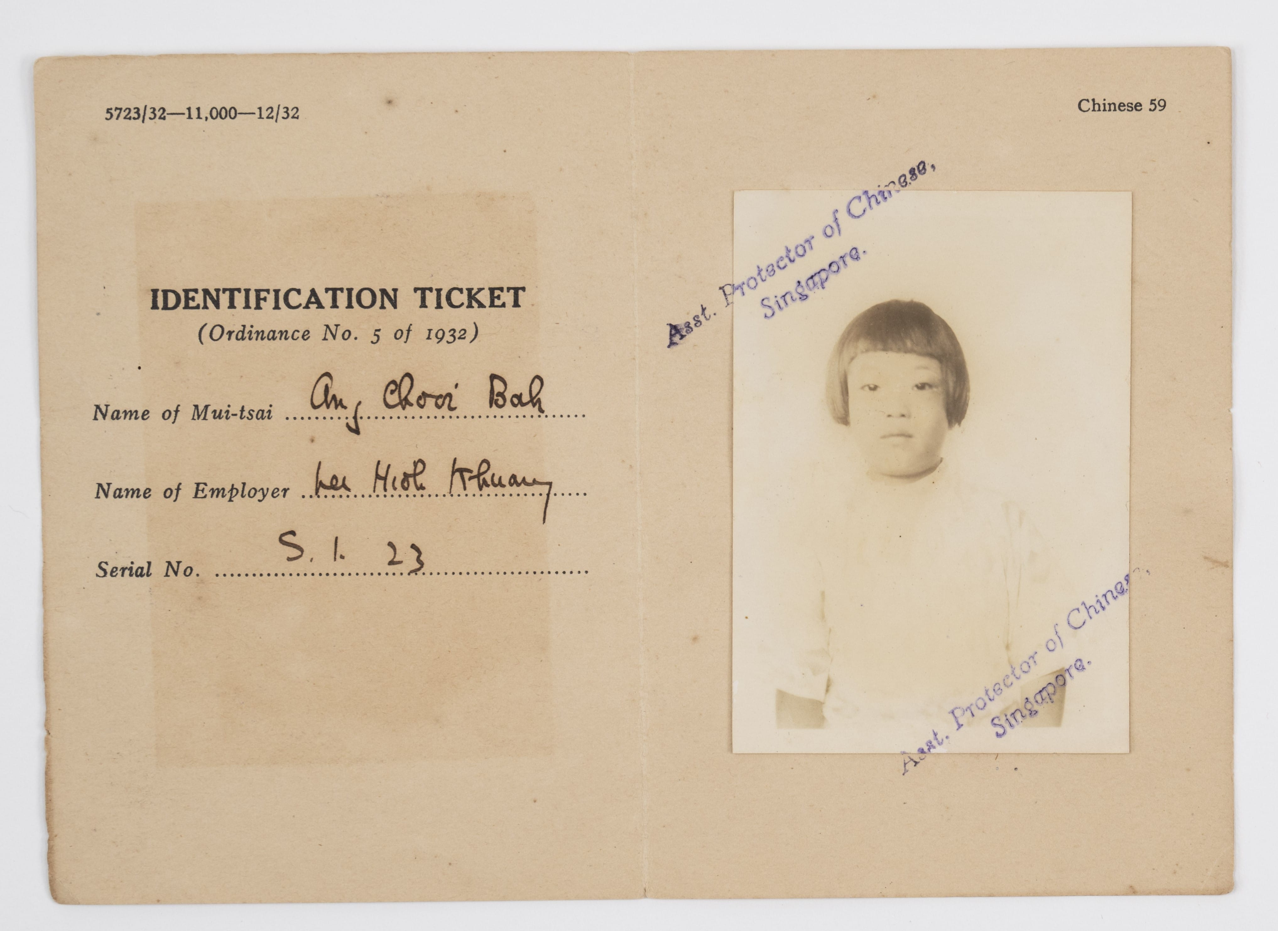 A 1932 Singapore Identification Ticket for a Mui-tsai named Ang Chooi Bah, with a child's photo and official stamps.