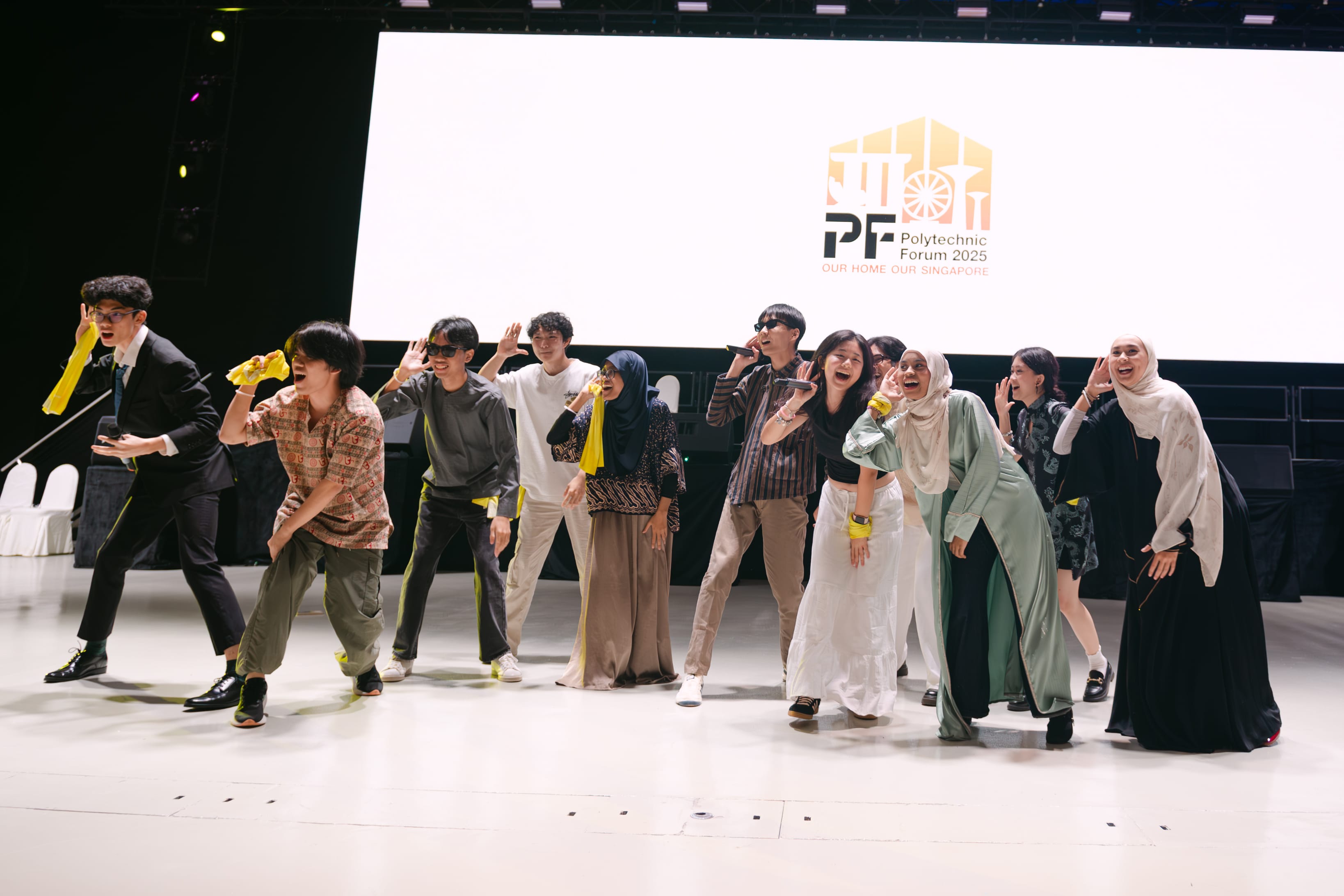 A group of young people performing energetically on stage at Polytechnic Forum 2025 in Singapore.