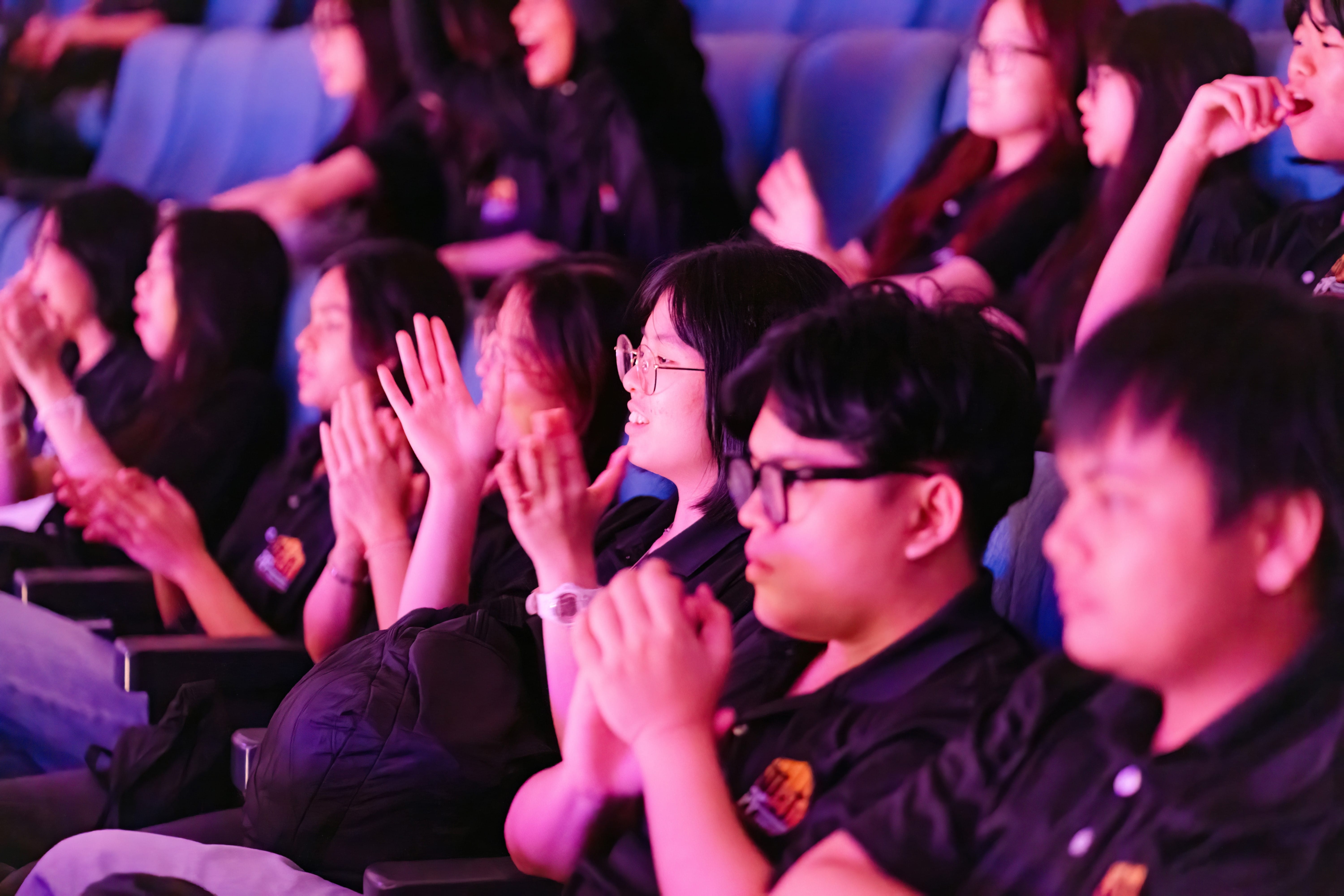 Audience clapping and smiling as they watch the performance.