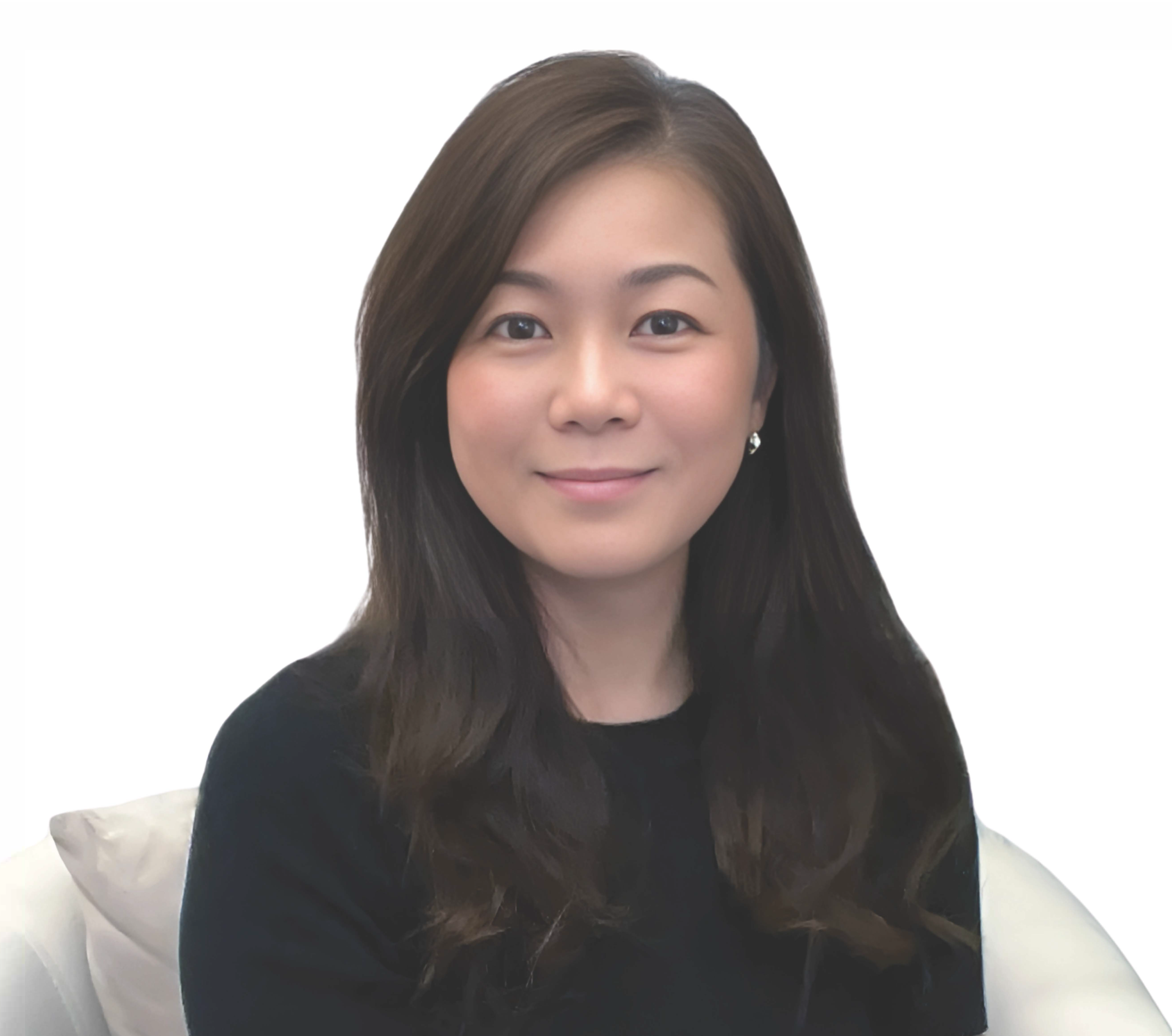 Woman with long dark brown hair, wearing a black top, smiling softly against a white background.