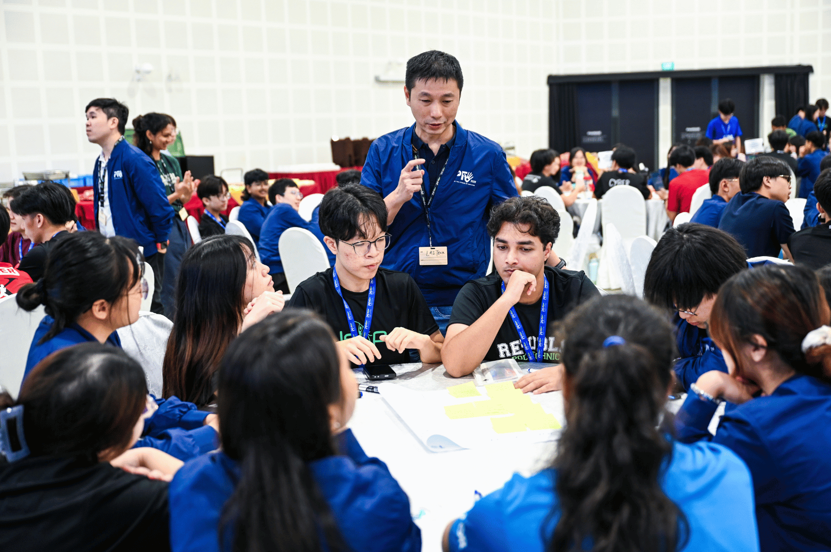 lead facilitator helping students in their discussion during workshop
