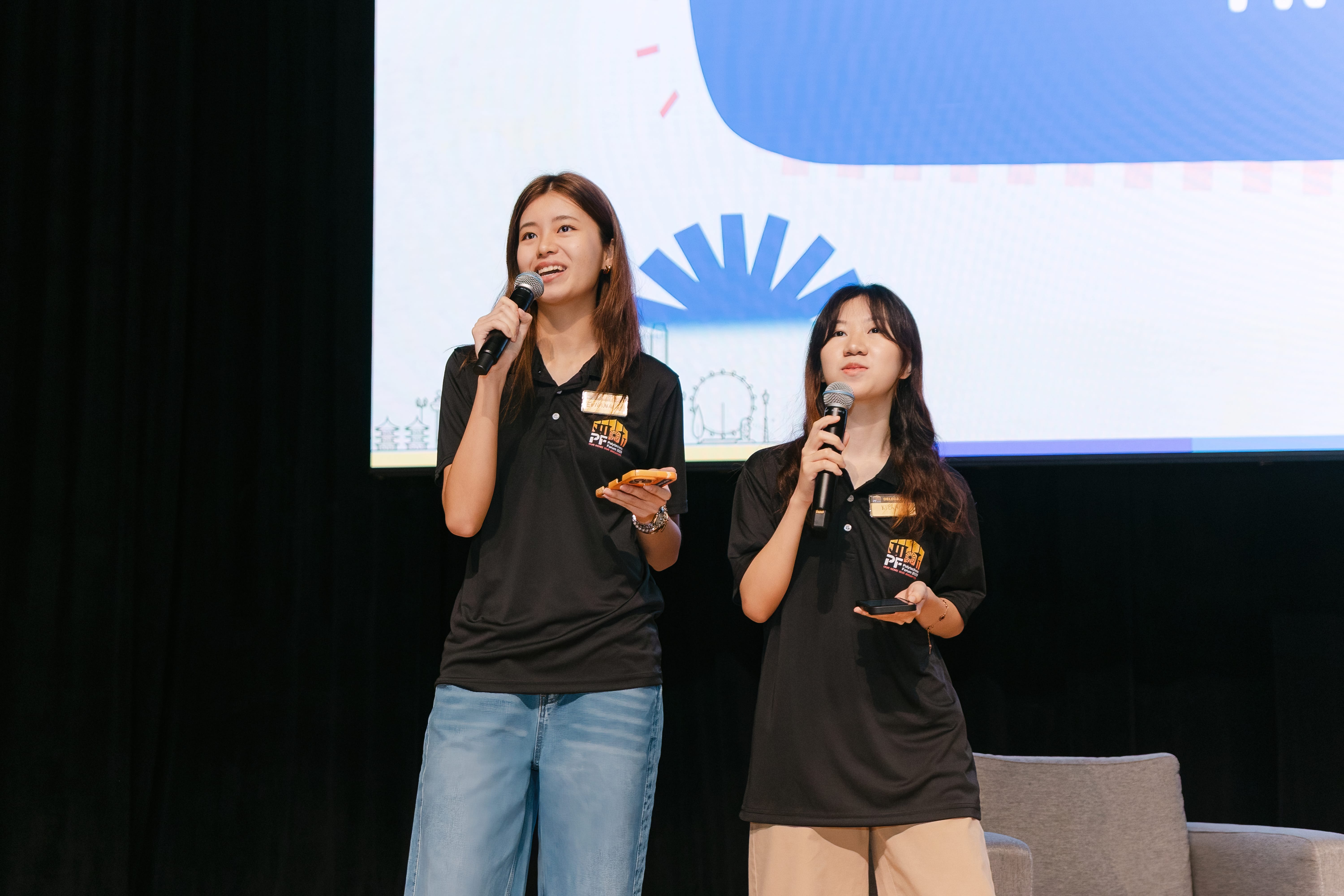 Two ladies holding a microphone