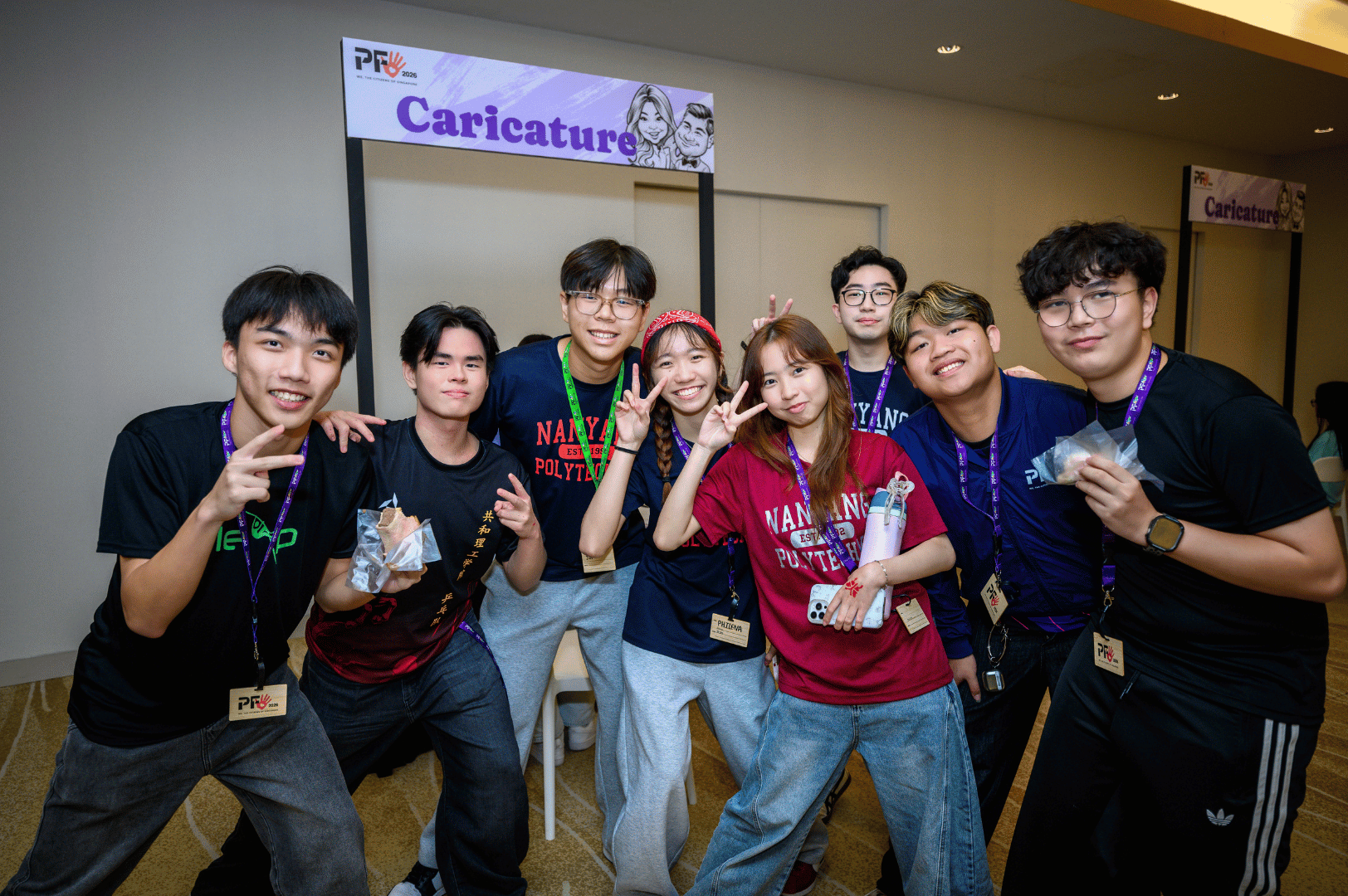 students posing near the caricature booth