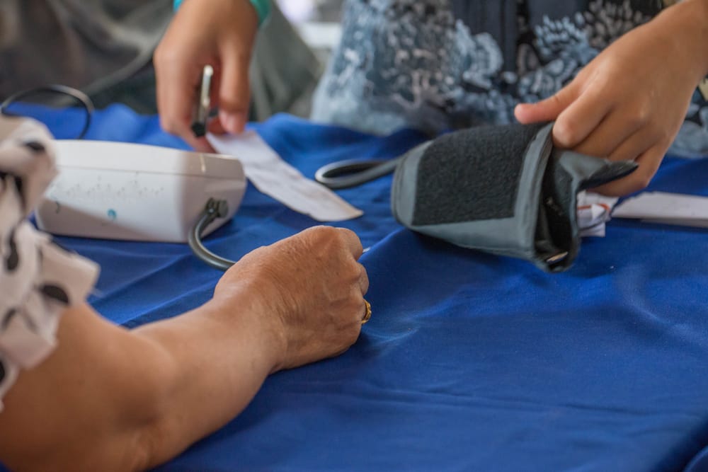 A close-up shot of a lady getting her blood pressure measured.