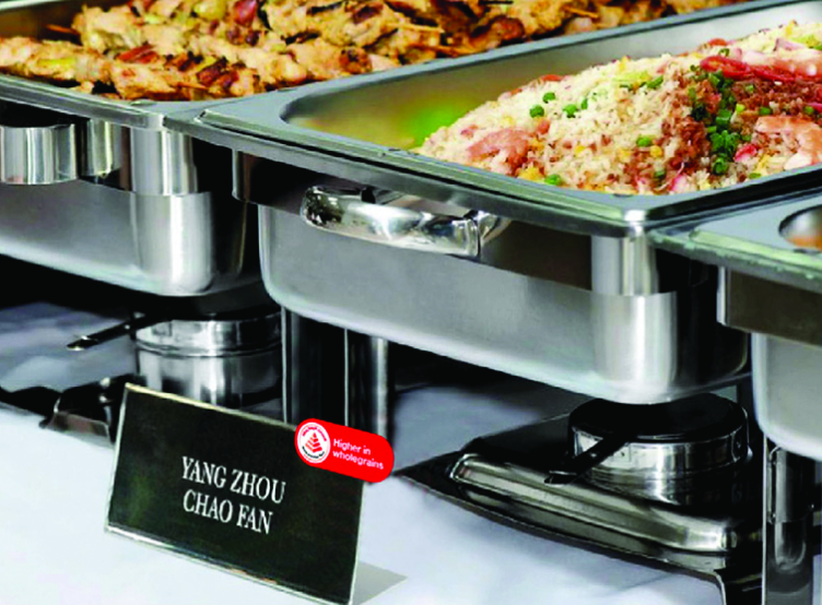 Buffet trays with sign indicating Yang Zhou chao fan made with higher-wholegrain ingredients.