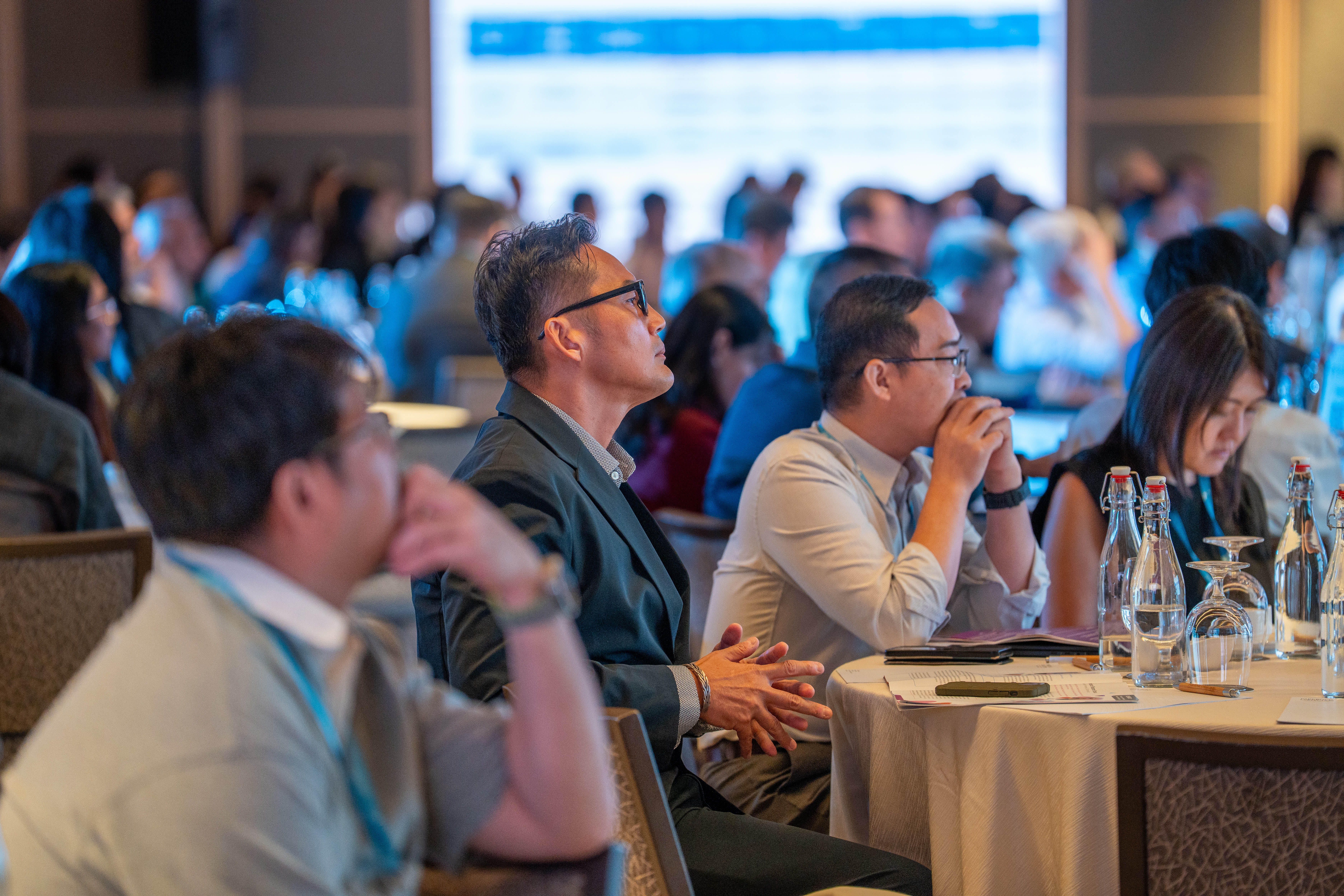 Guests enjoying a presentation on stage
