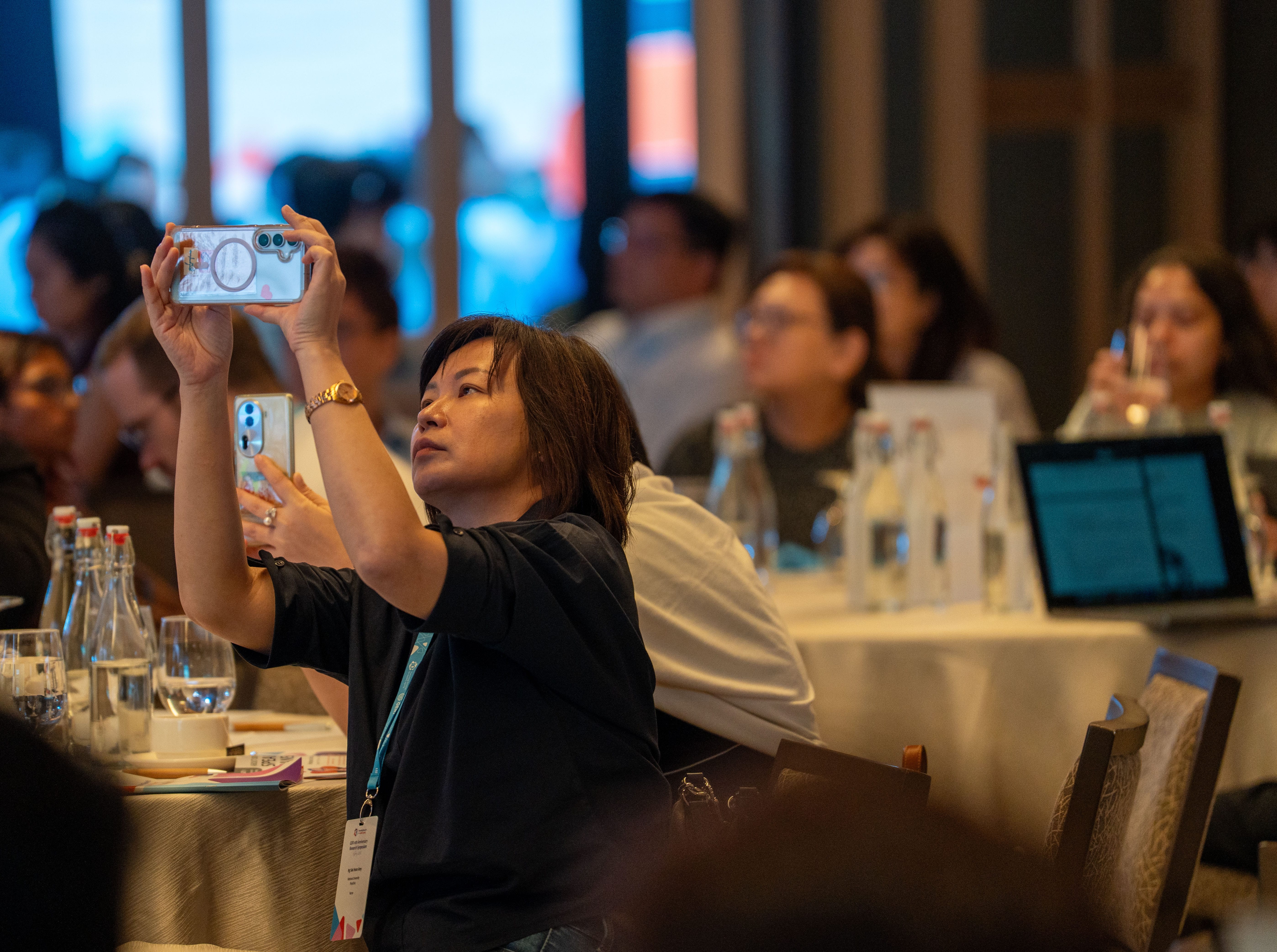 Guest taking a photo of presentation