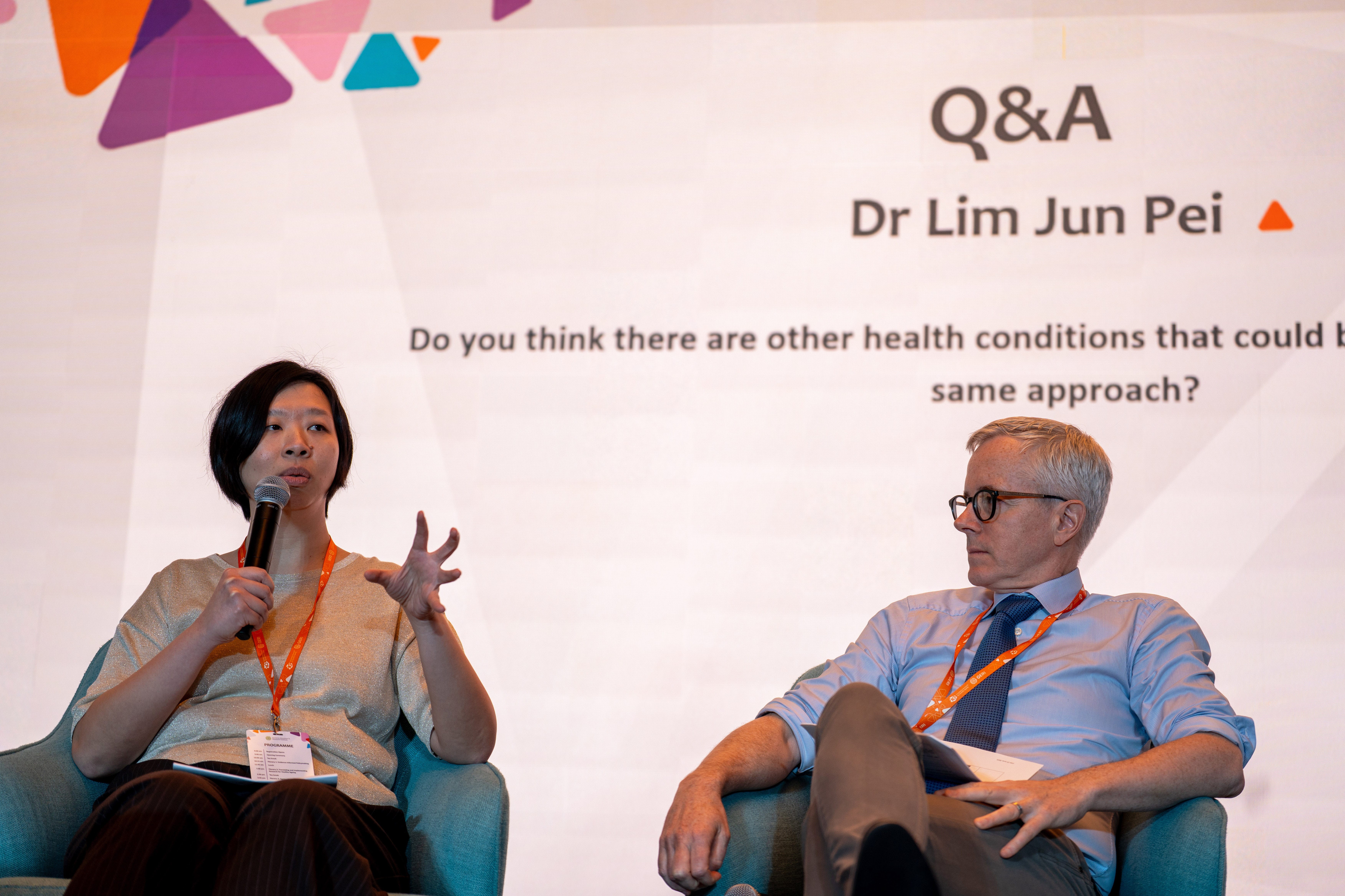 Speakers answering a question on stage
