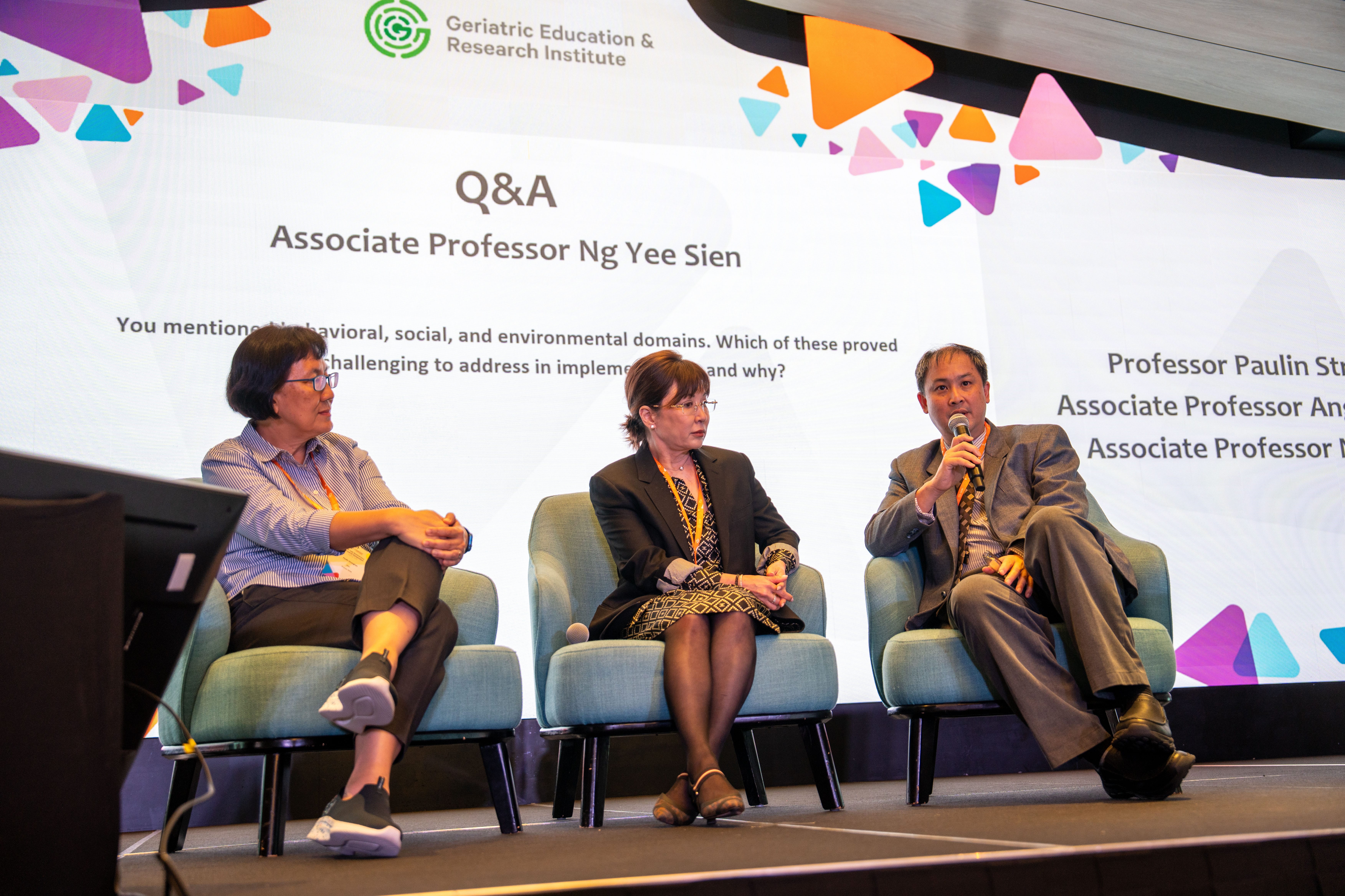 Speakers answering questions on stage