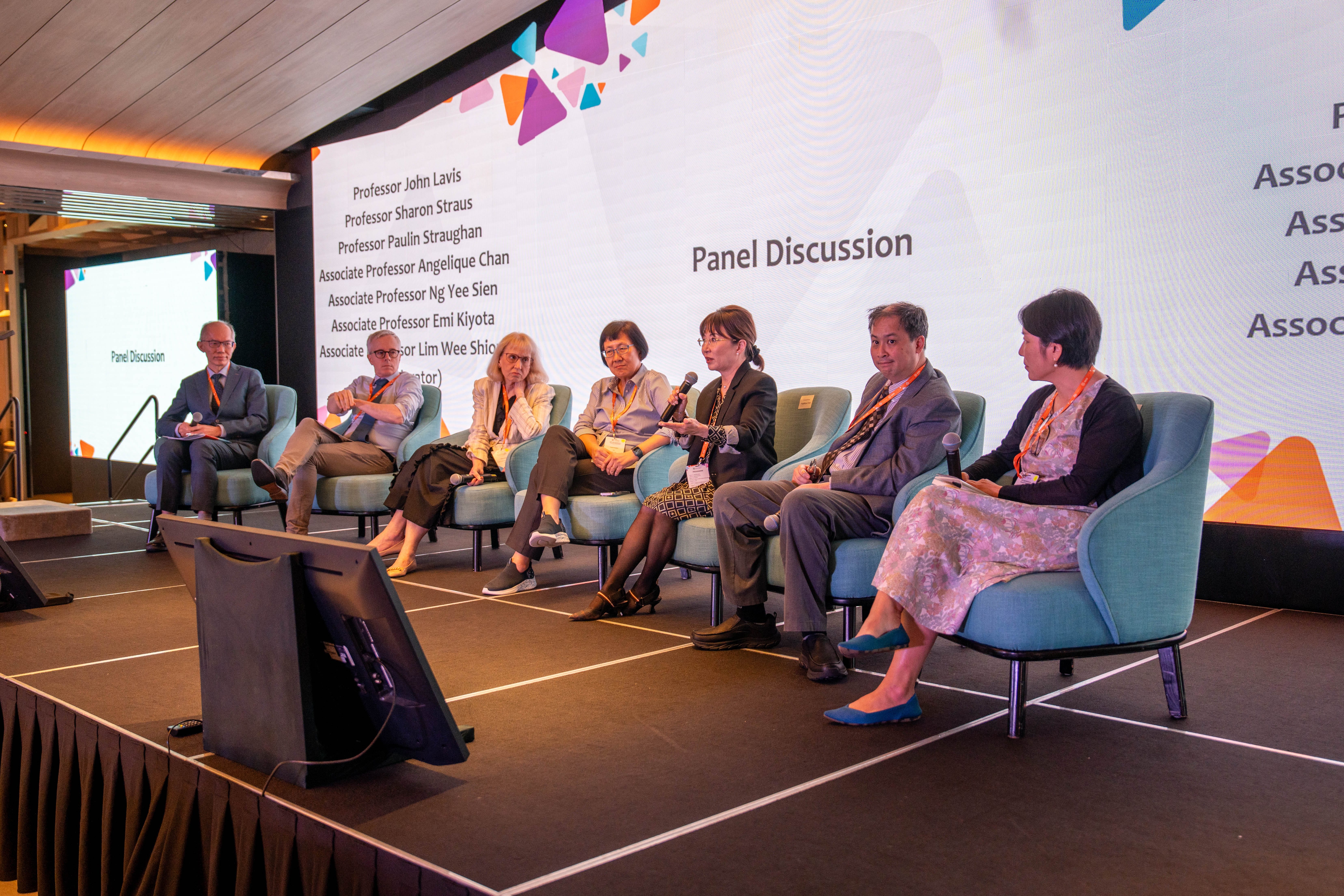 A group of panellists on stage