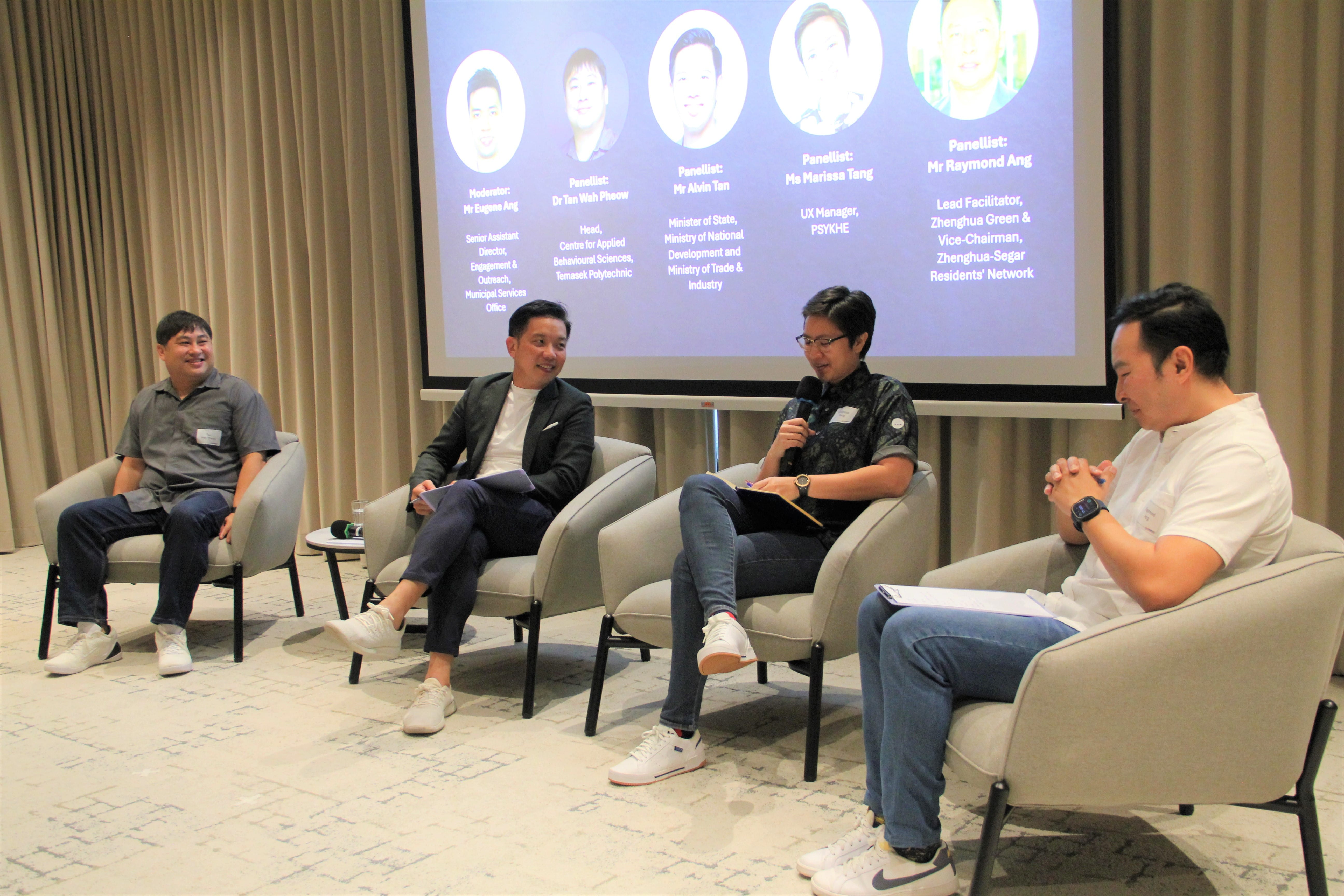 Panel discussion with four speakers seated on stage at OSK 2025 event.