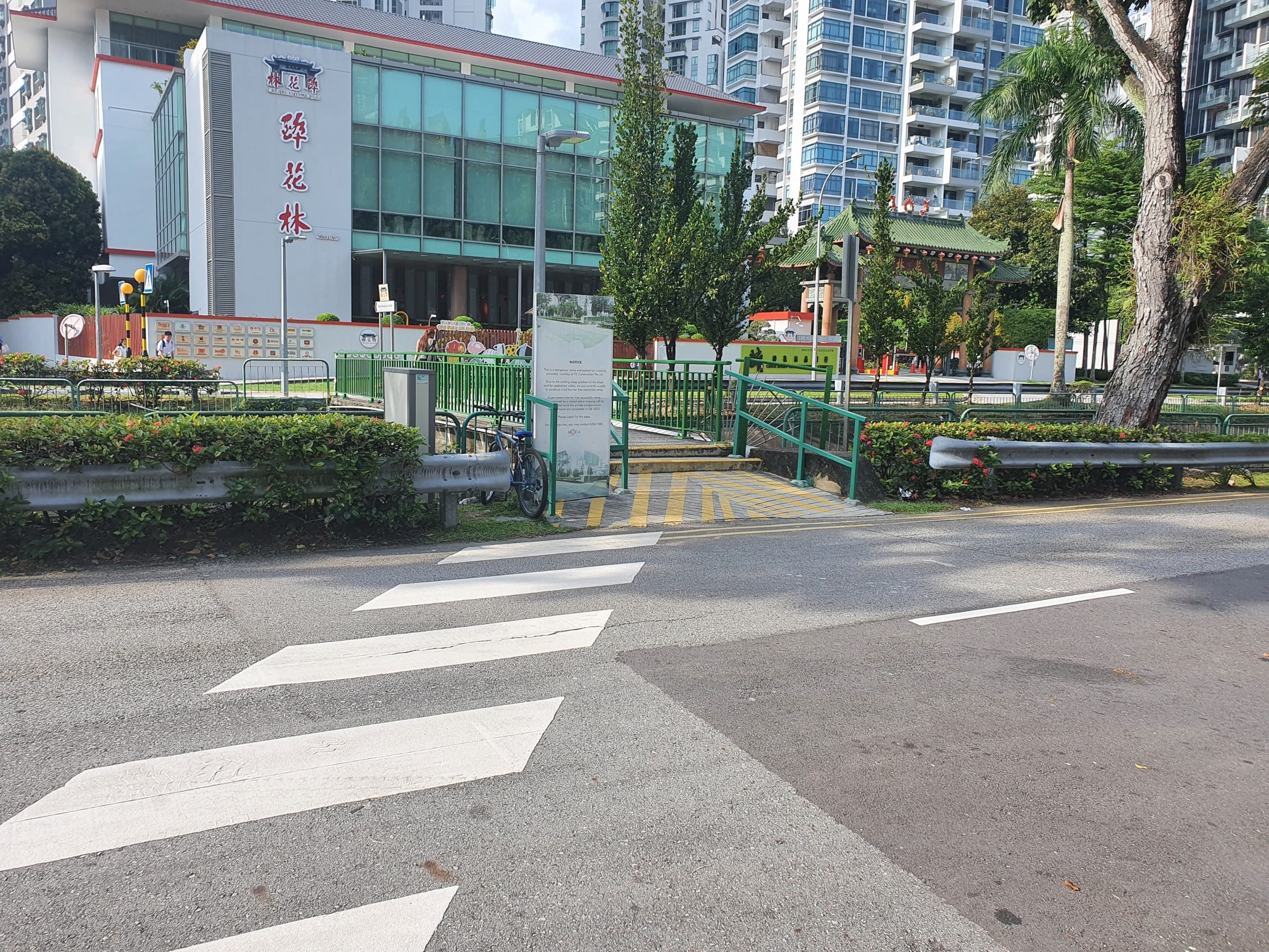 Street view showing a zebra crossing, Chui Huay Lim Club, and high-rise buildings.