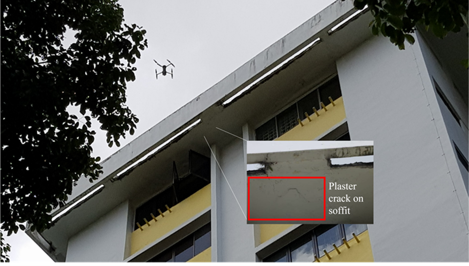 Drone inspecting building facade with inset showing plaster crack on soffit.