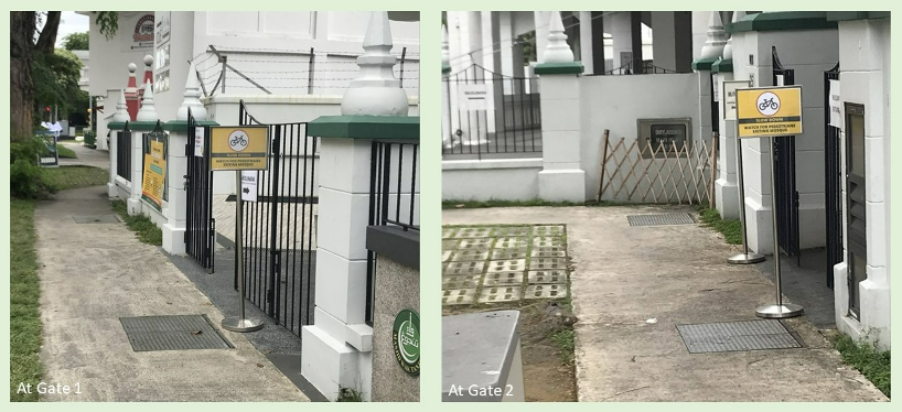Two gates with "Slow Down Watch for Pedestrians Exiting Mosque" signs near a building.