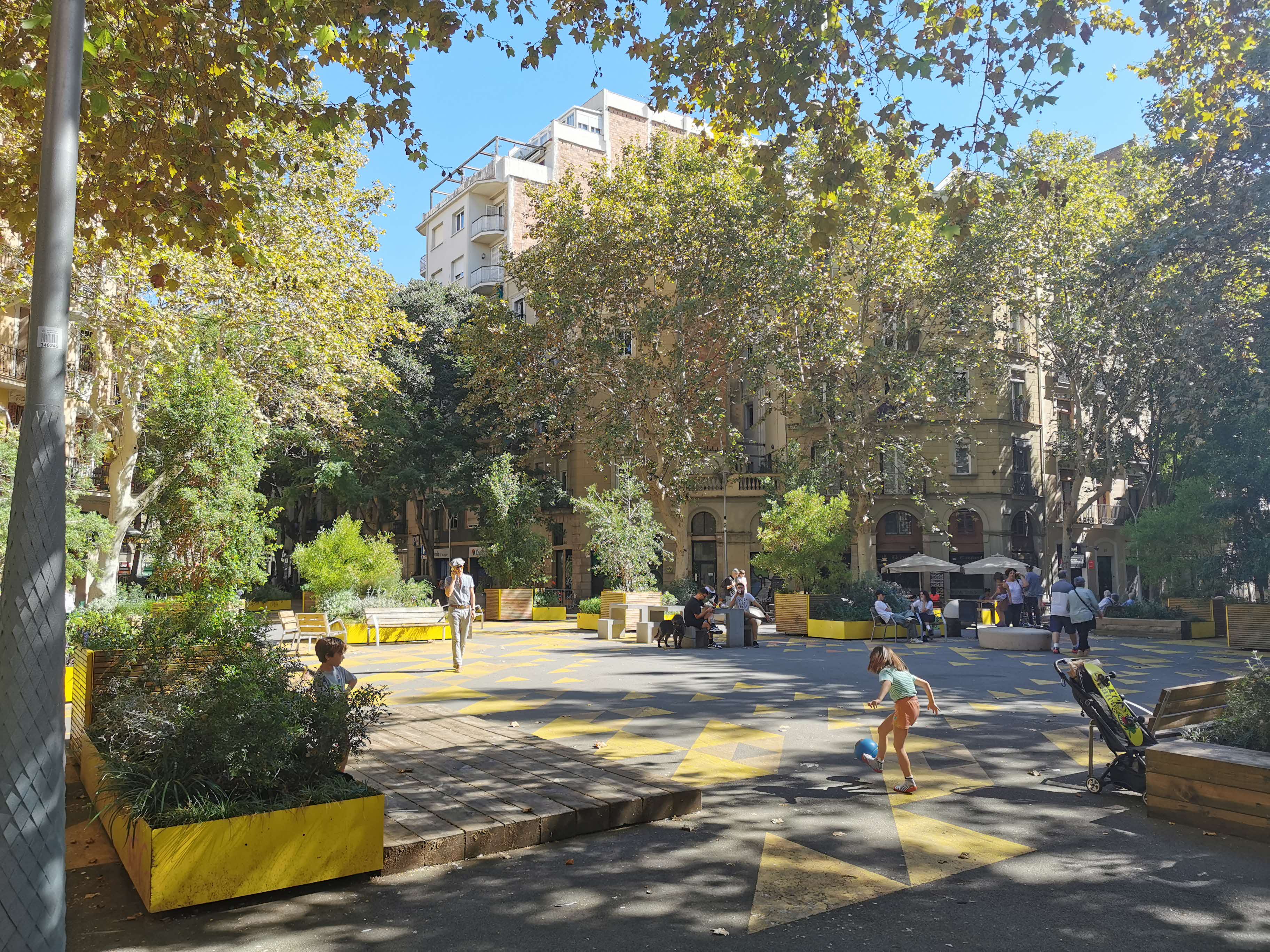 Photo of people relaxing at a former intersection in Poblenou