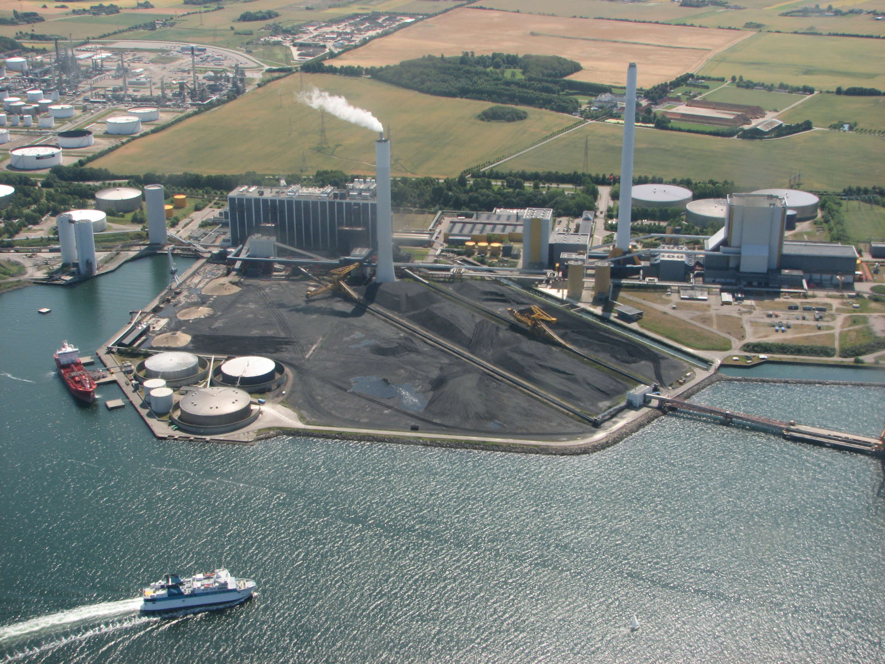 Aerial view of the Asnæs Power Plant, with smoke coming out of its smokestack