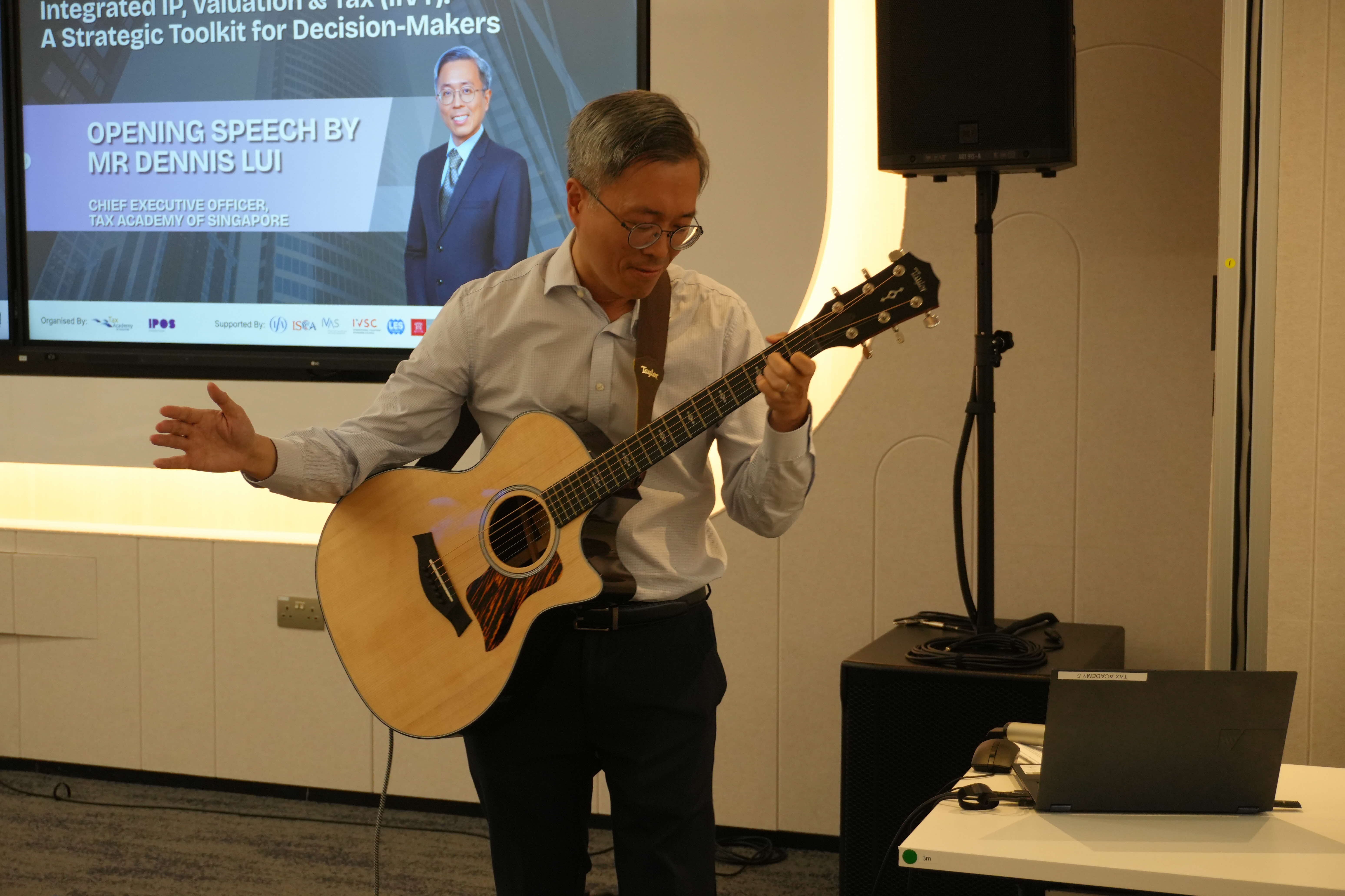 TA CEO Dennis Lui playing the guitar