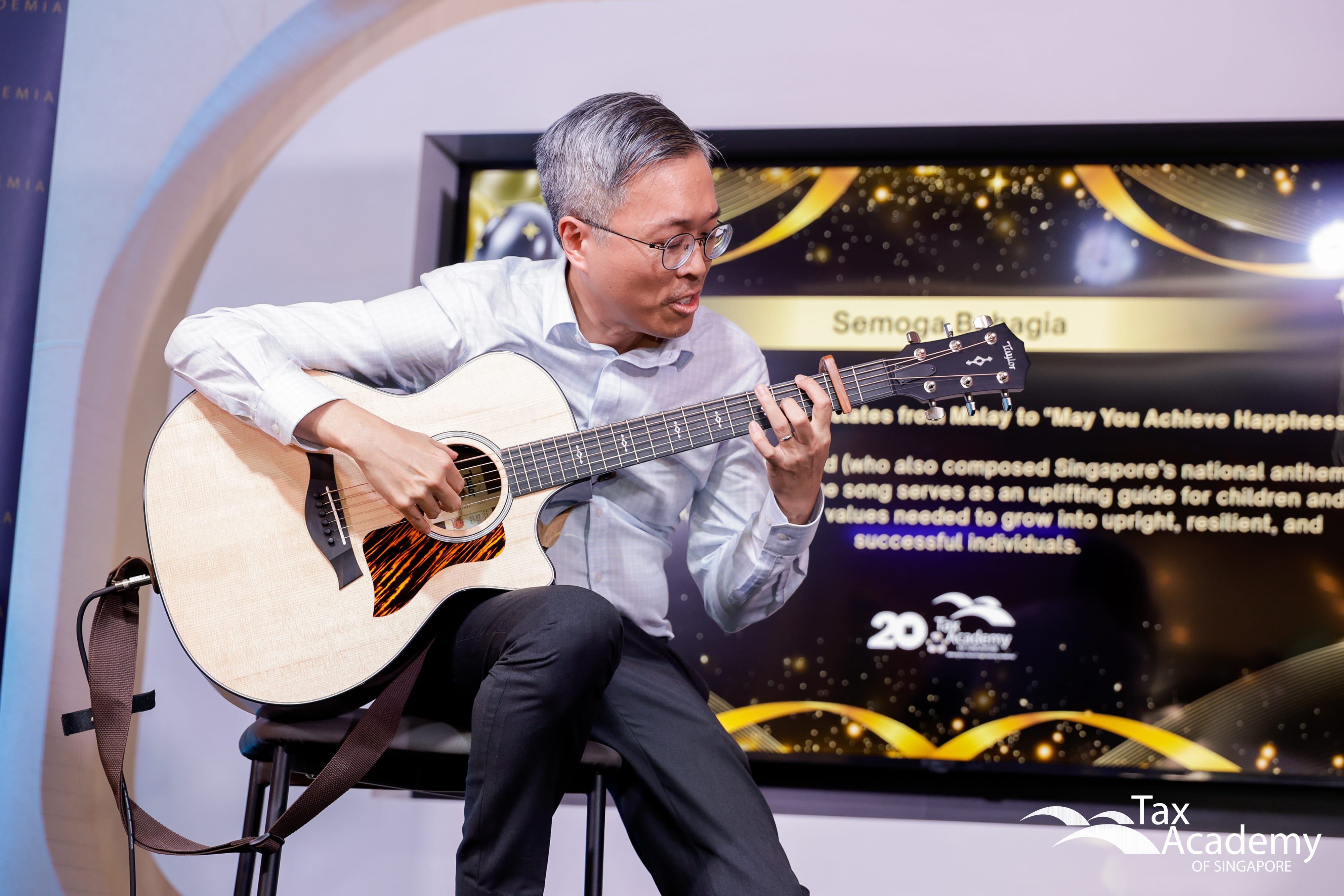 CEO Tax Academy of Singapore, Mr Dennis Lui, Playing the Guitar at the Opening of Tax Academy of Singapore Hub