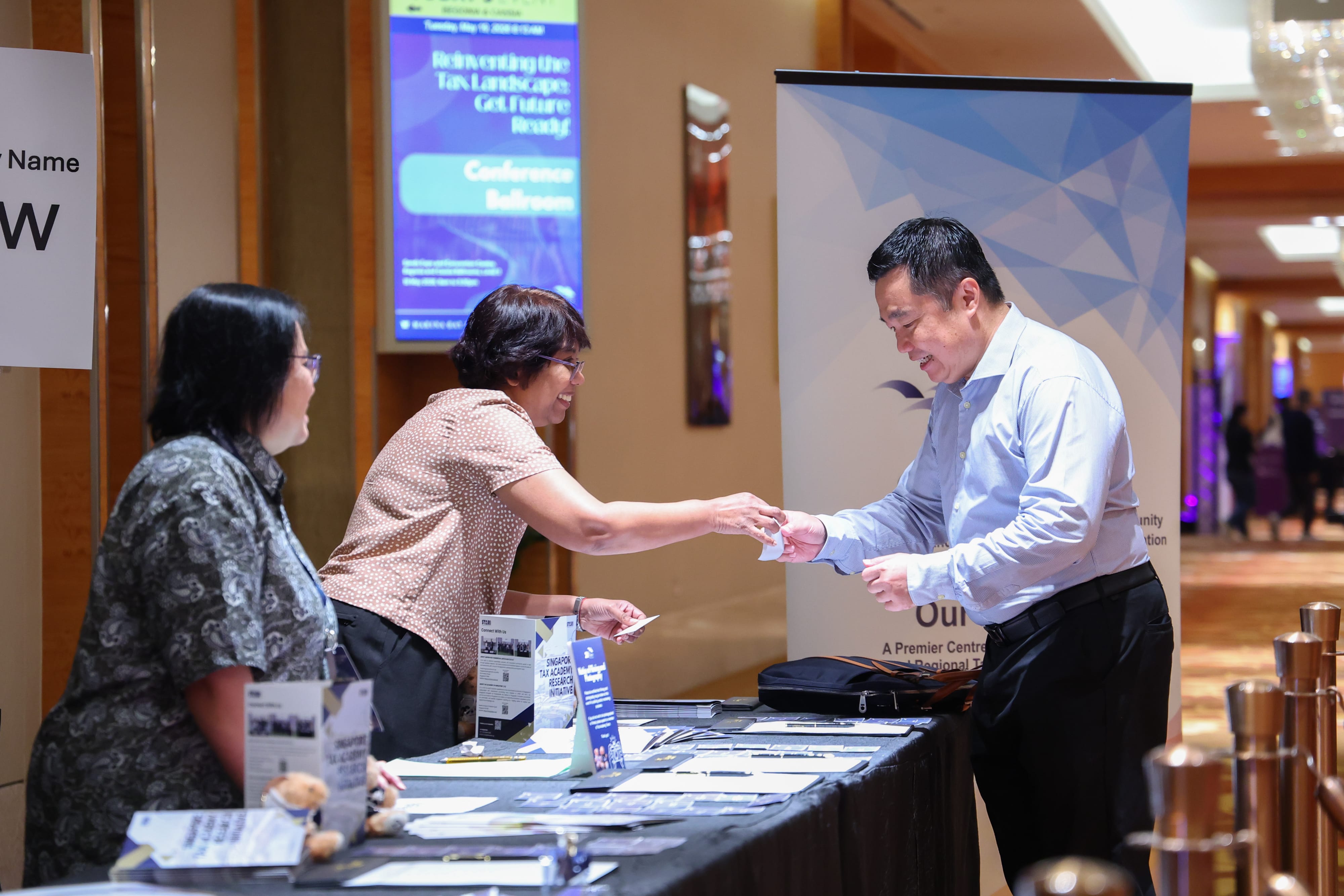 Welcoming delegates as they arrive for Tax Academy's 20th Anniversary Conference