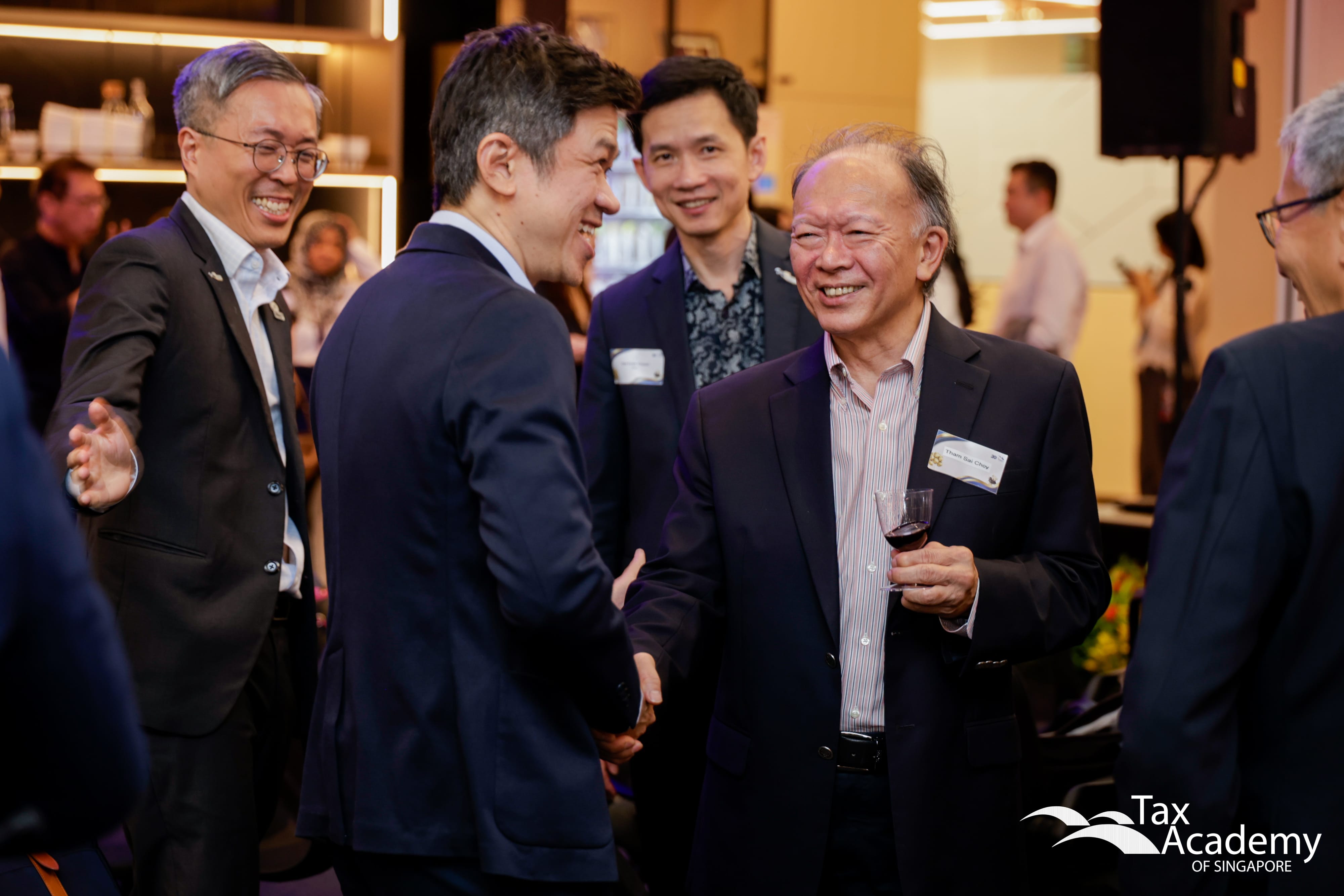 Commissioner of Inland Revenue, Mr Ow Fook Chuen, Chairman of Tax Academy Board, Mr Tham Sai Choy, and CEO of Tax Academy, Mr Dennis Lui, Ushering a VIP
