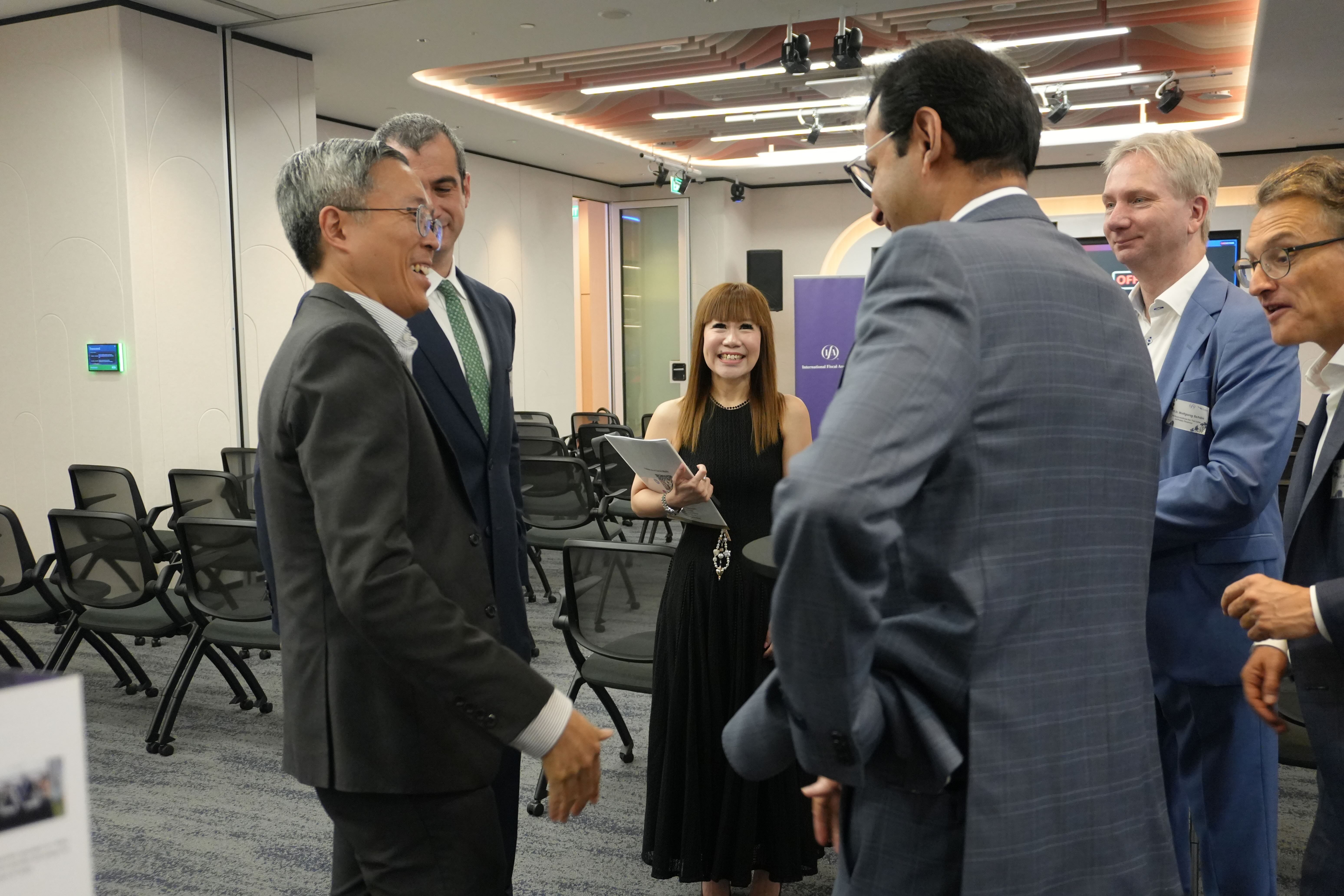 CEO of Tax Academy of Singapore networking with speakers and panellists..