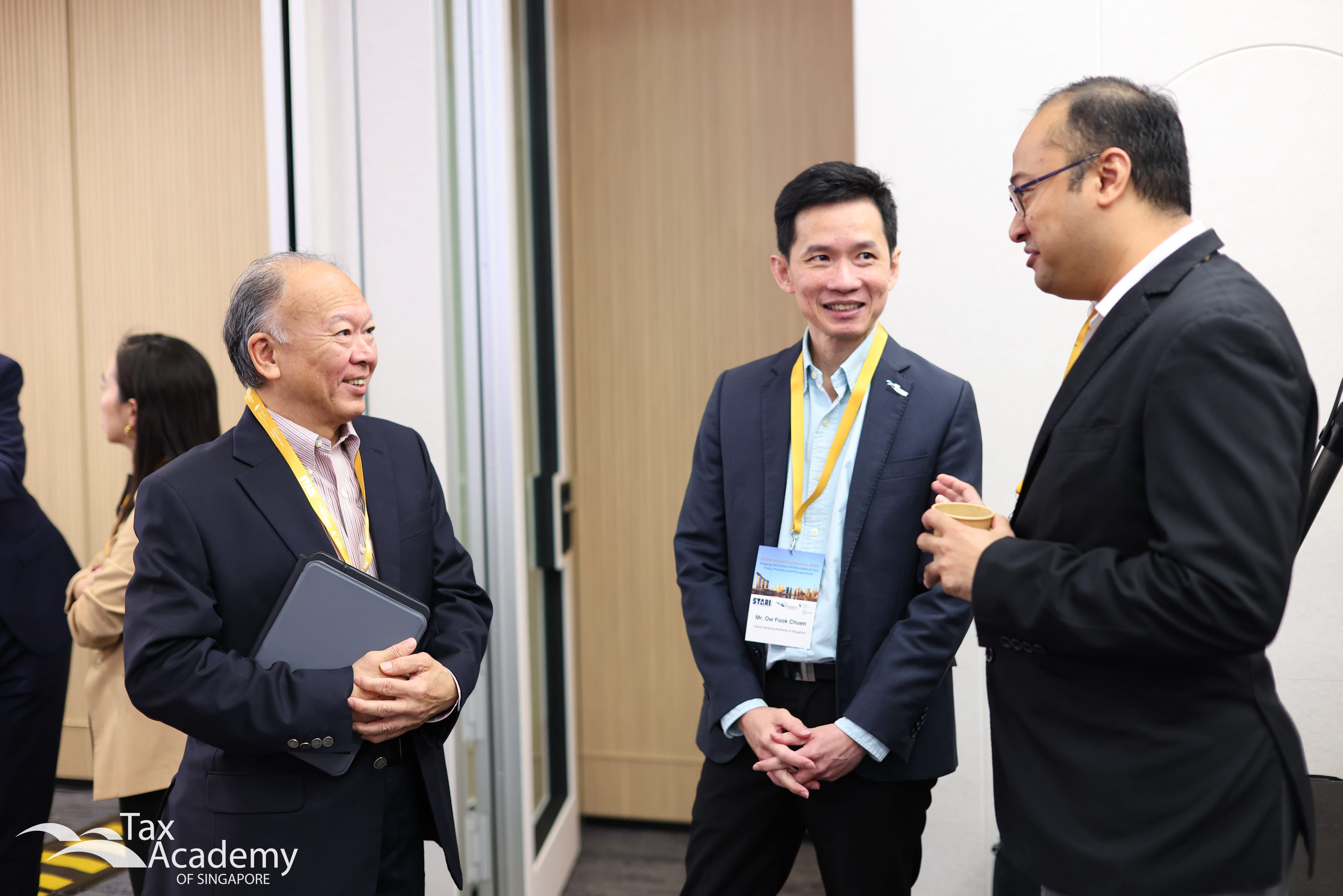 Commissioner of IRAS, Mr Ow Fook Chuen, Tax Academy Chairman, Mr Tham Sai Choy, and Mr Fazli, having a conversation