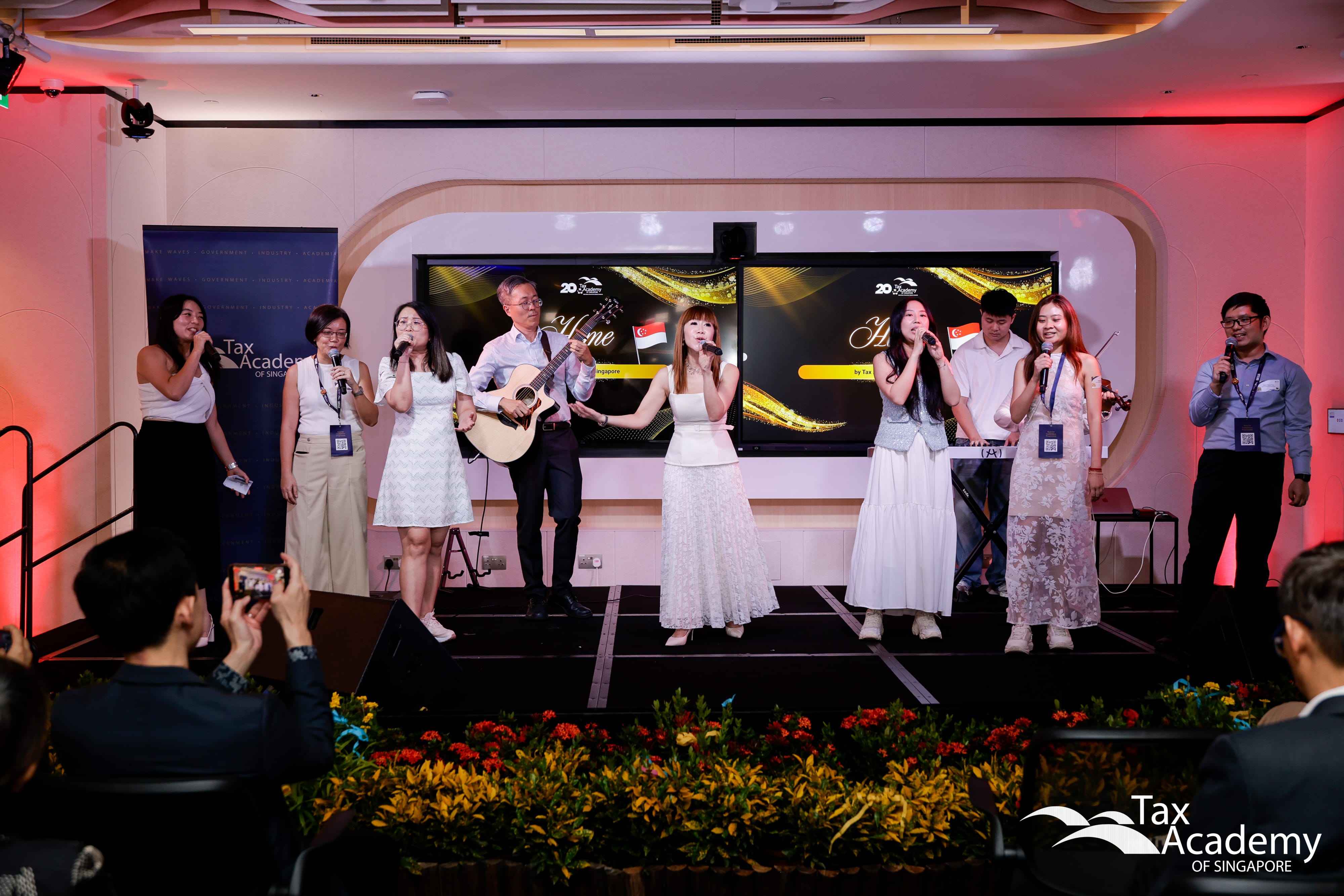 The Tax Academy team singing in unison during the Special Performance at the Opening of the Tax Academy of Singapore Hub