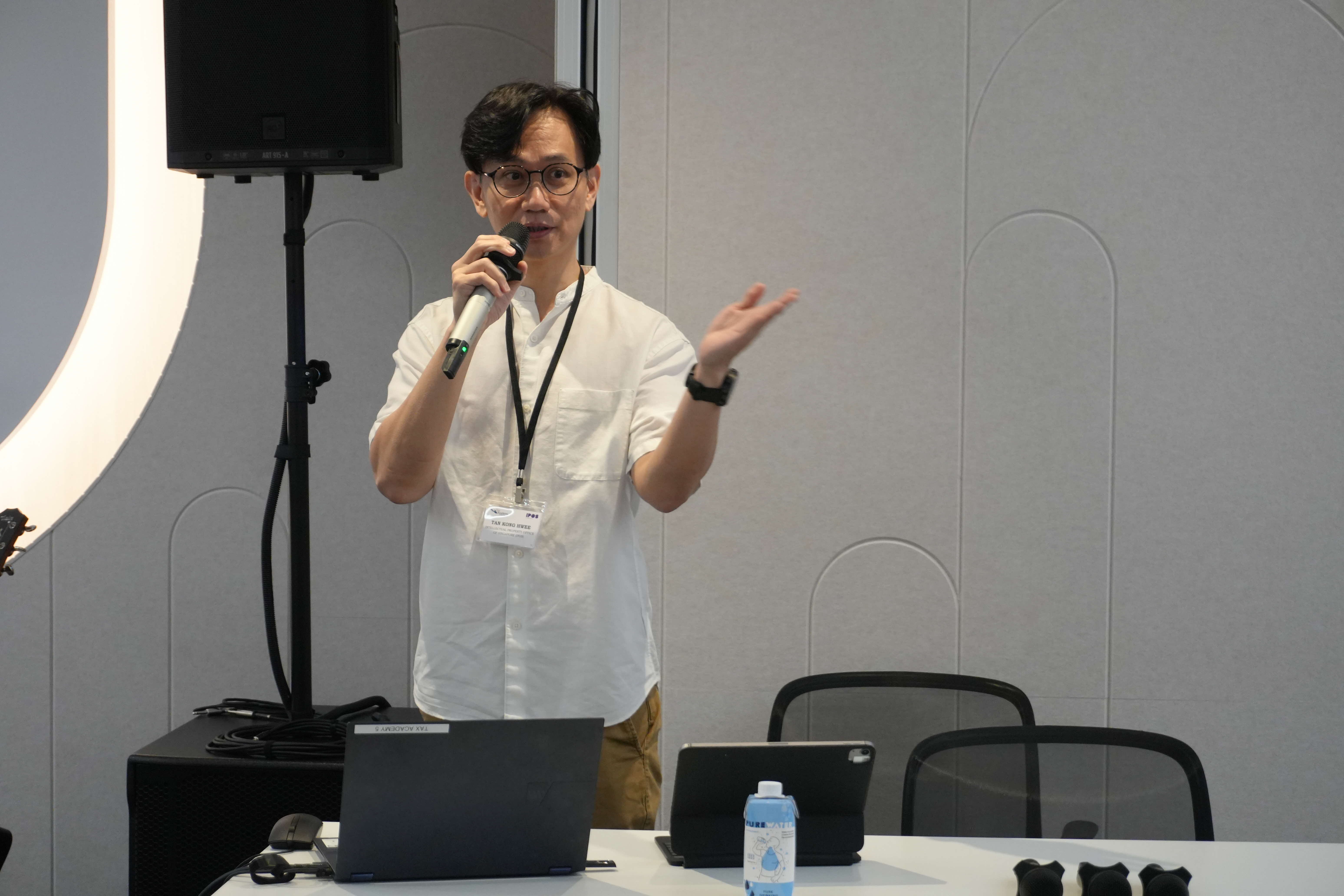 IPOS CE Tan Kong Hwee giving his opening speech