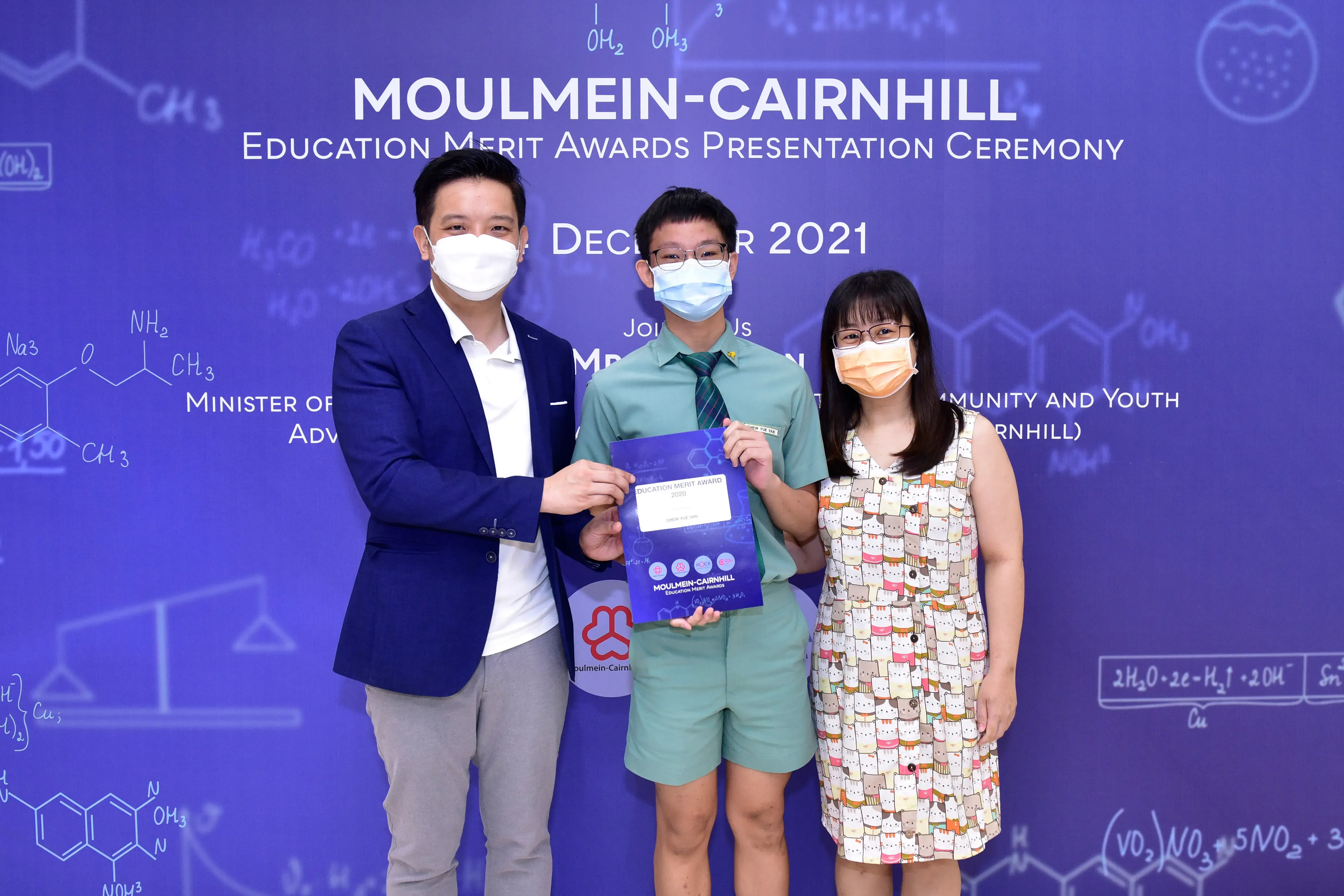 Three masked people pose at the Moulmein-Cairnhill Education Merit Awards Ceremony, December 2021.