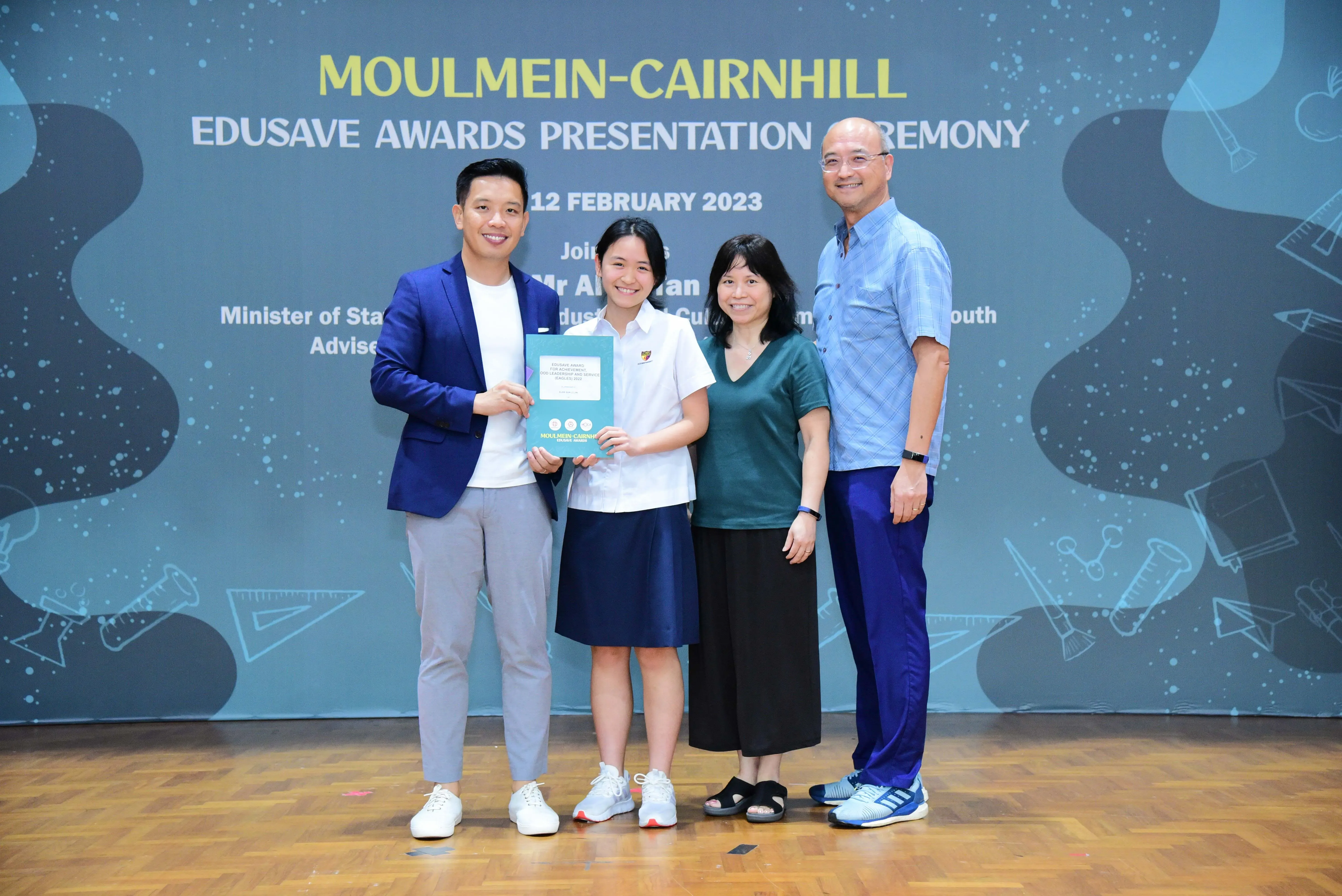 Four people pose at the Moulmein-Cairnhill Edusave Awards Presentation Ceremony on 12 February 2023.