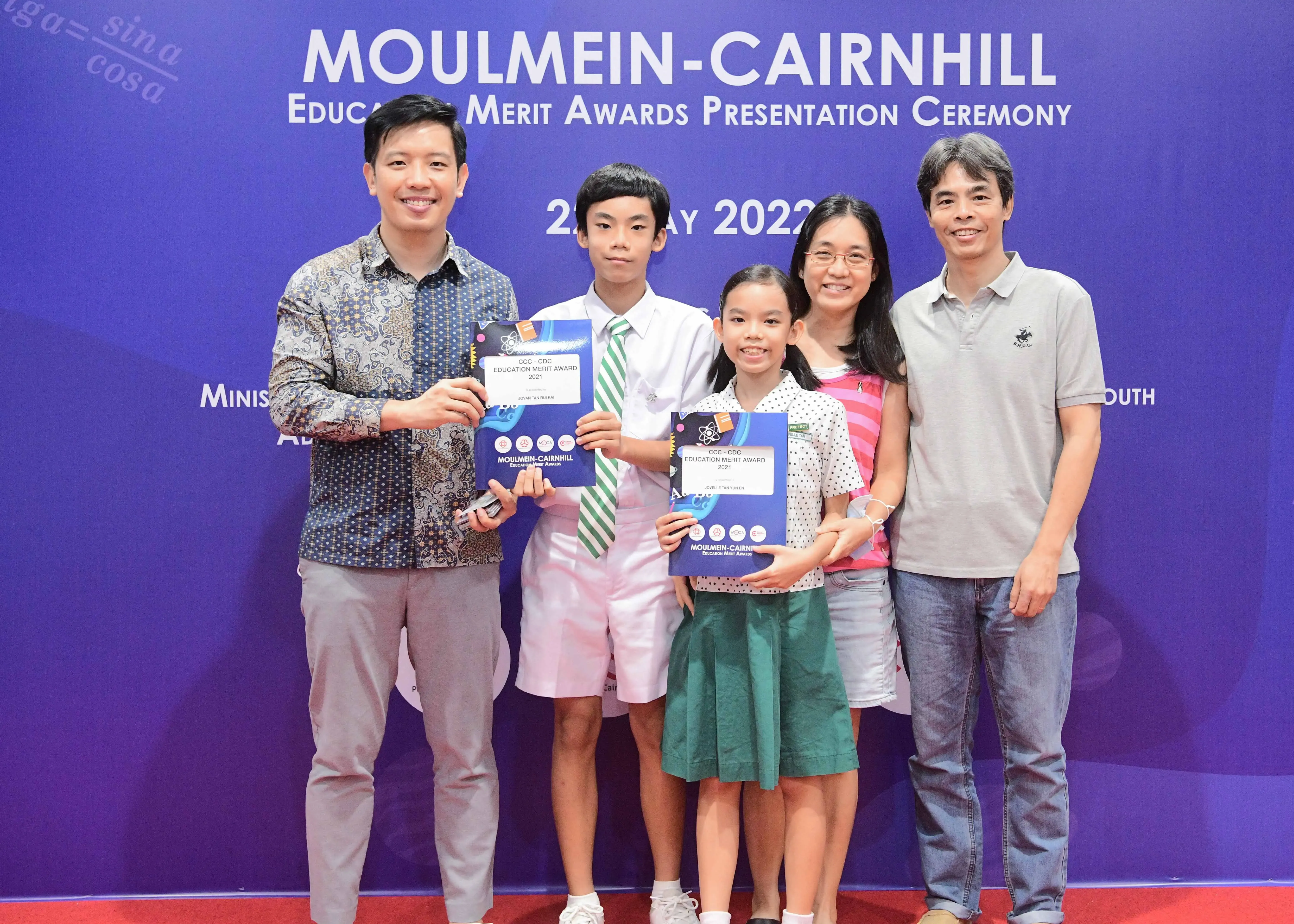 Five people pose with award certificates at the Moulmein-Cairnhill Education Merit Awards Ceremony 2022.