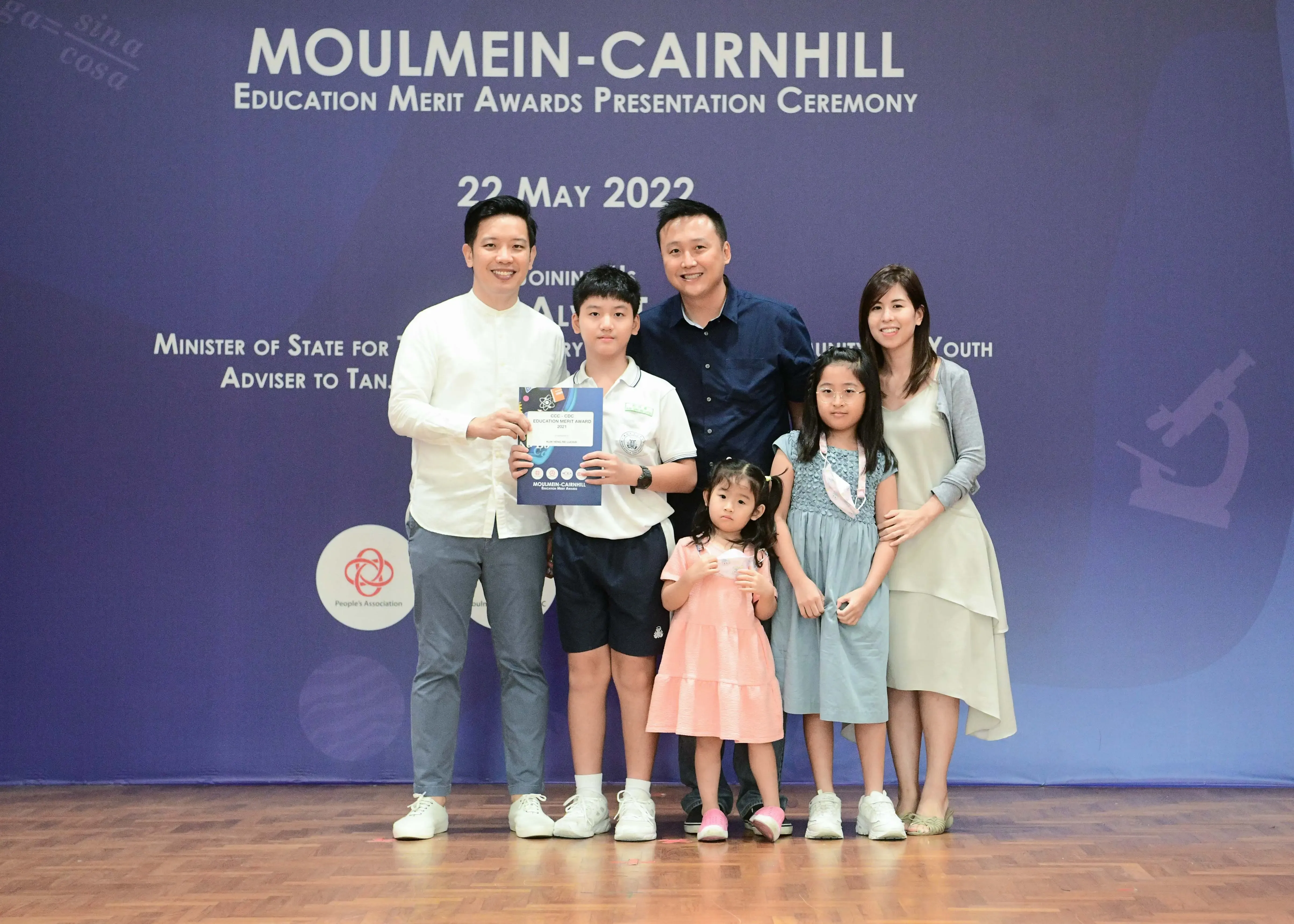 Group of six people posing with an award certificate at the Moulmein-Cairnhill Education Merit Awards on 22 May 2022.