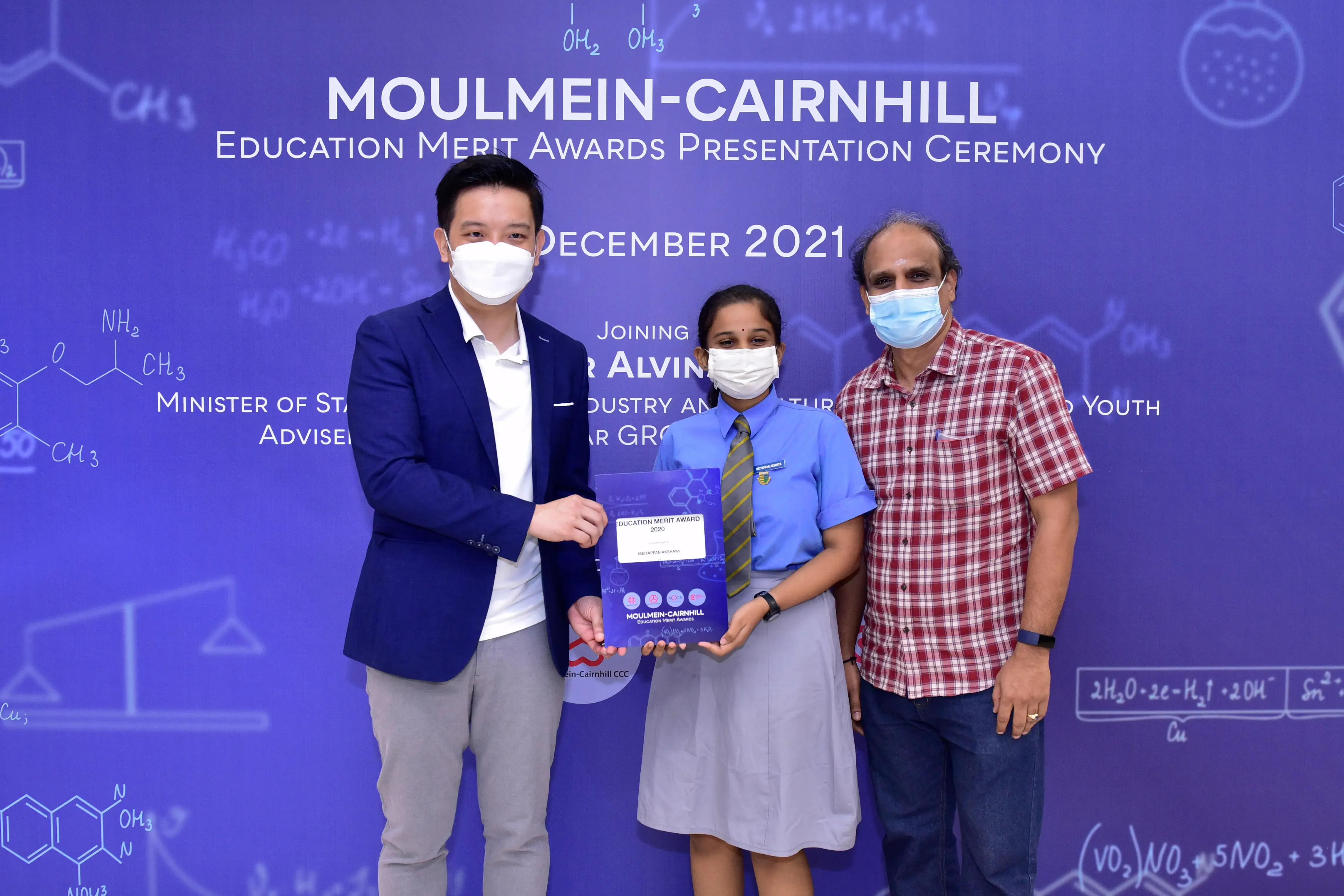 Three masked people pose at the Moulmein-Cairnhill Education Merit Awards Ceremony, December 2021.